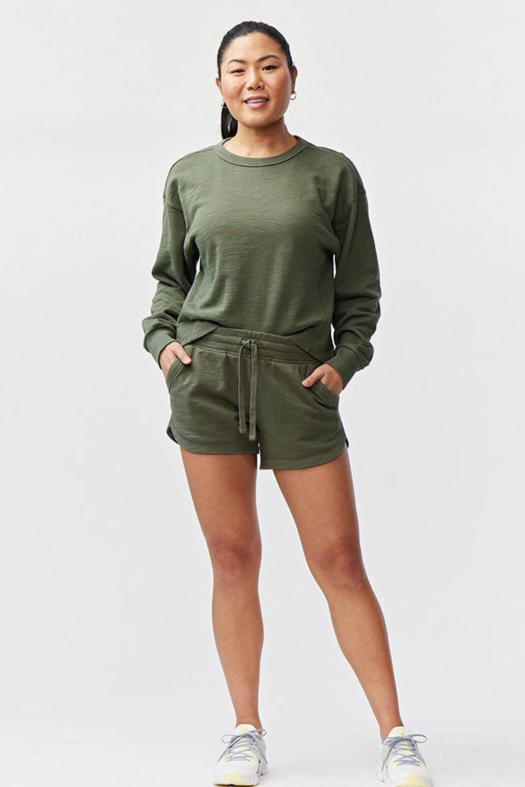 Freasy Short in olive green cotton with a drawstring waist, relaxed fit and front pockets, styled with a matching sweatshirt