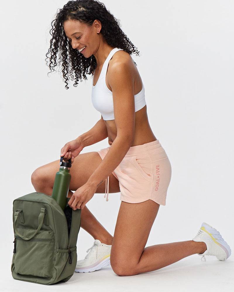 Freasy Short in pale peach cotton with a wide waistband, drawstring, side pockets and vertical leg lettering