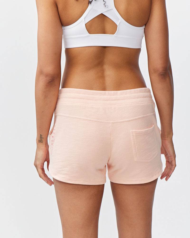 Freasy Short in pale pink cotton with a wide rib-knit waistband and a single visible back pocket