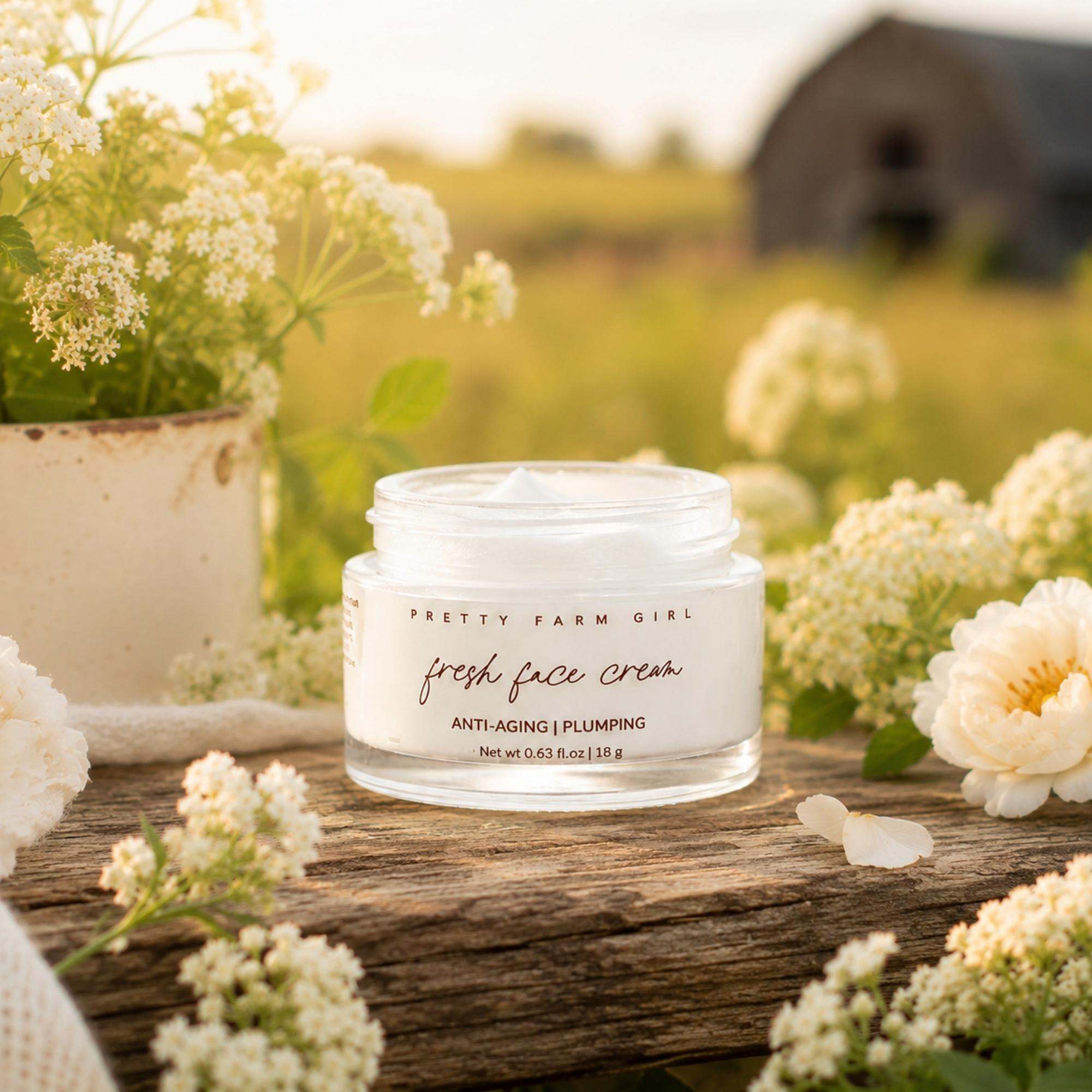 Fresh Face Cream in a clear glass jar with a white label and black lettering, featuring anti-aging and plumping text