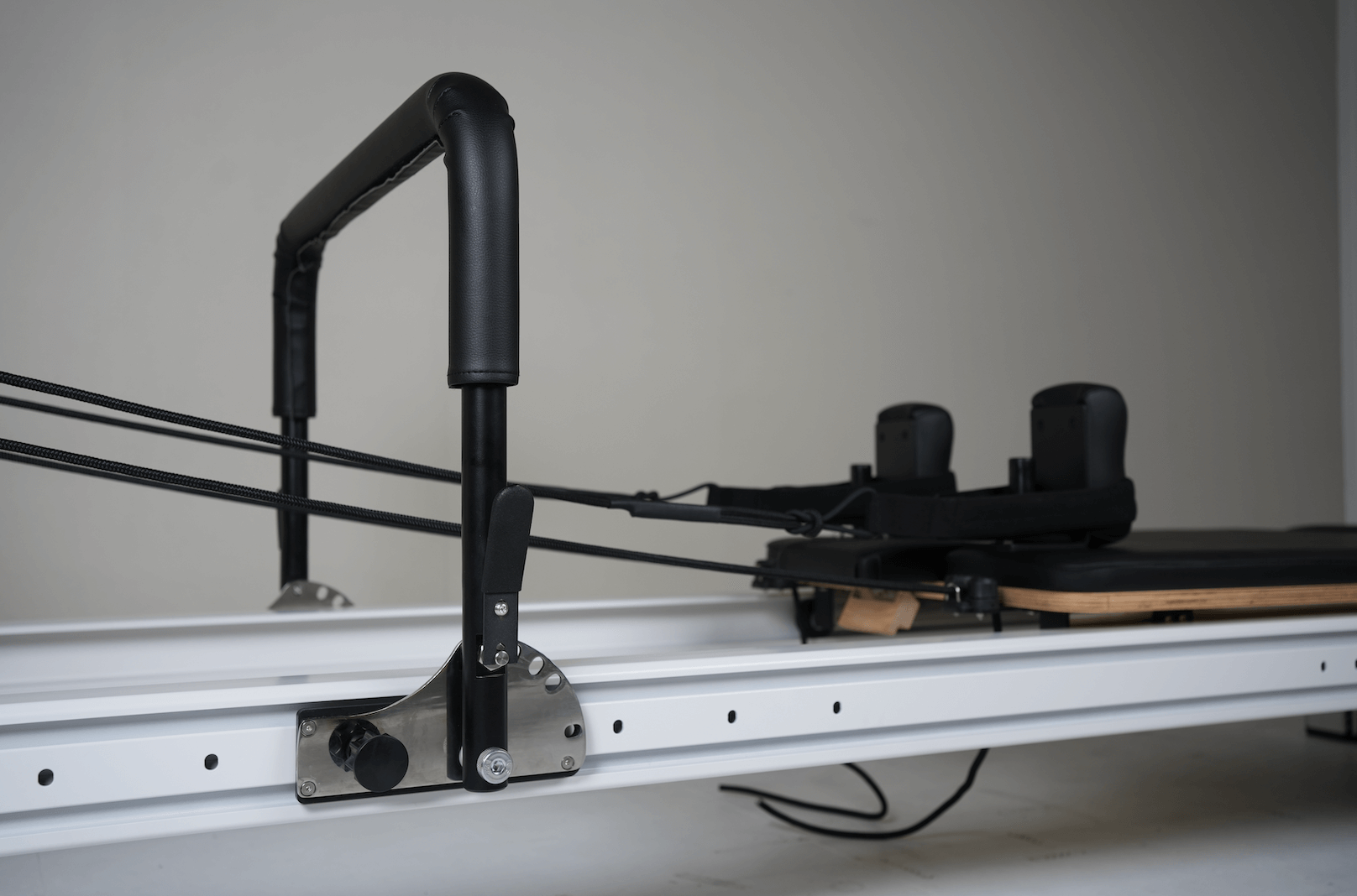 Full Track Queen Studio Pilates Reformer with black frame and upholstery