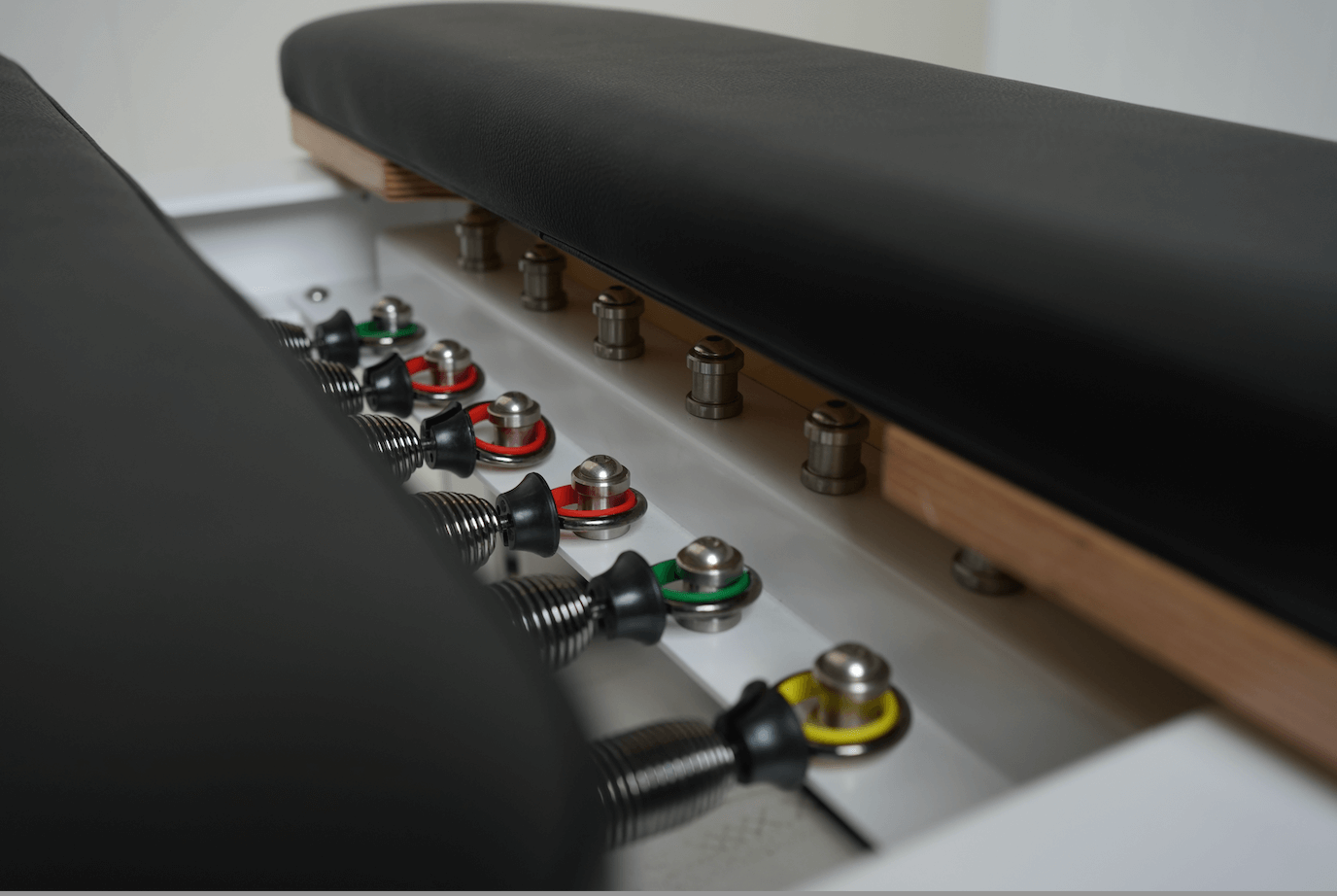 Full Track Queen Studio Pilates Reformer with black frame and upholstery
