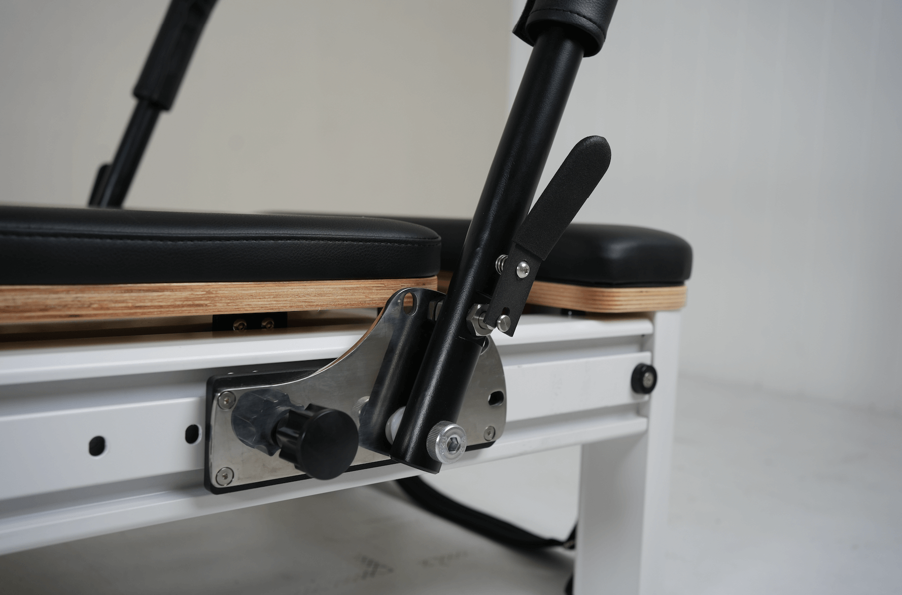 Full Track Queen Studio Pilates reformer with sliding footbar and black upholstery