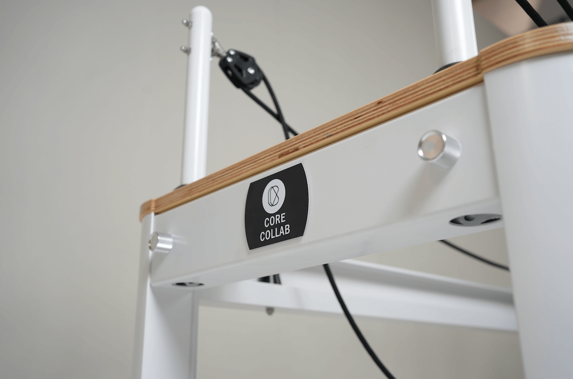 Full Track Queen Studio Pilates Reformer with sliding footbar and black upholstery