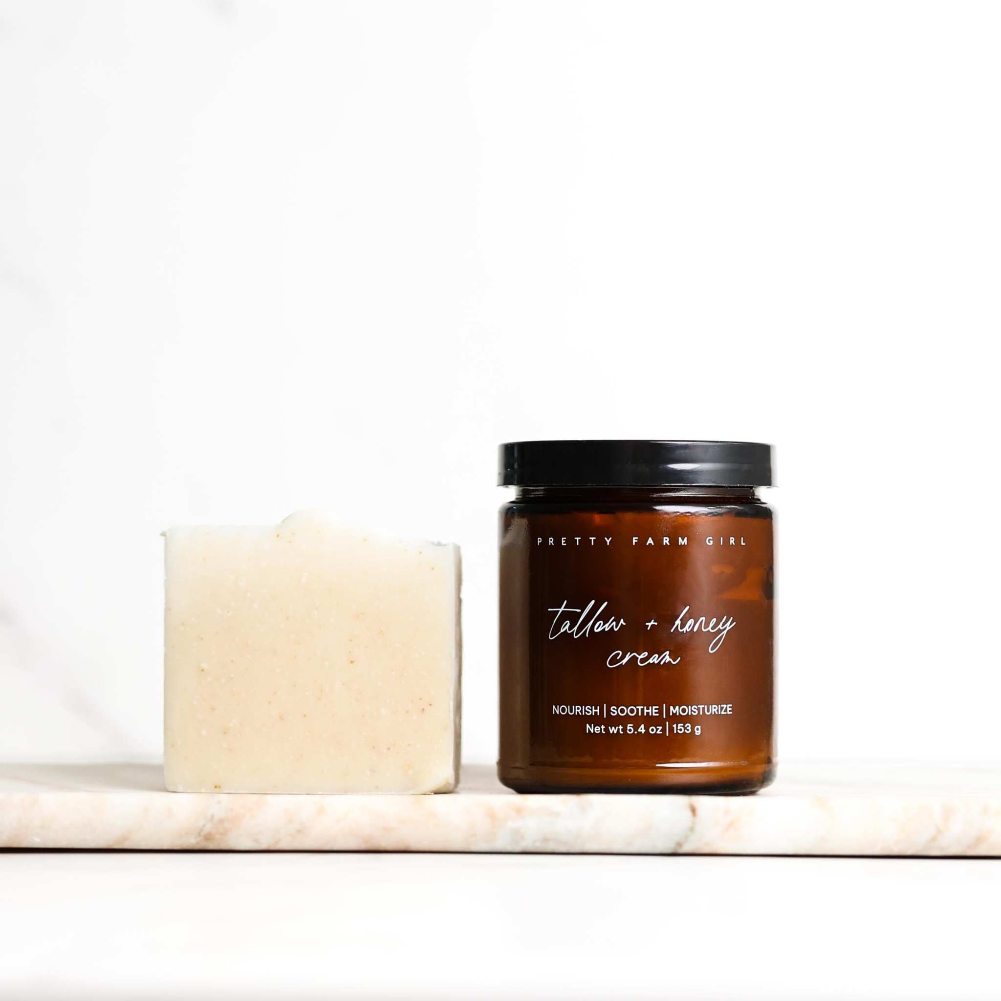 Gentle Care Duo for Mom + Baby with an ivory soap bar and amber glass tallow honey cream jar