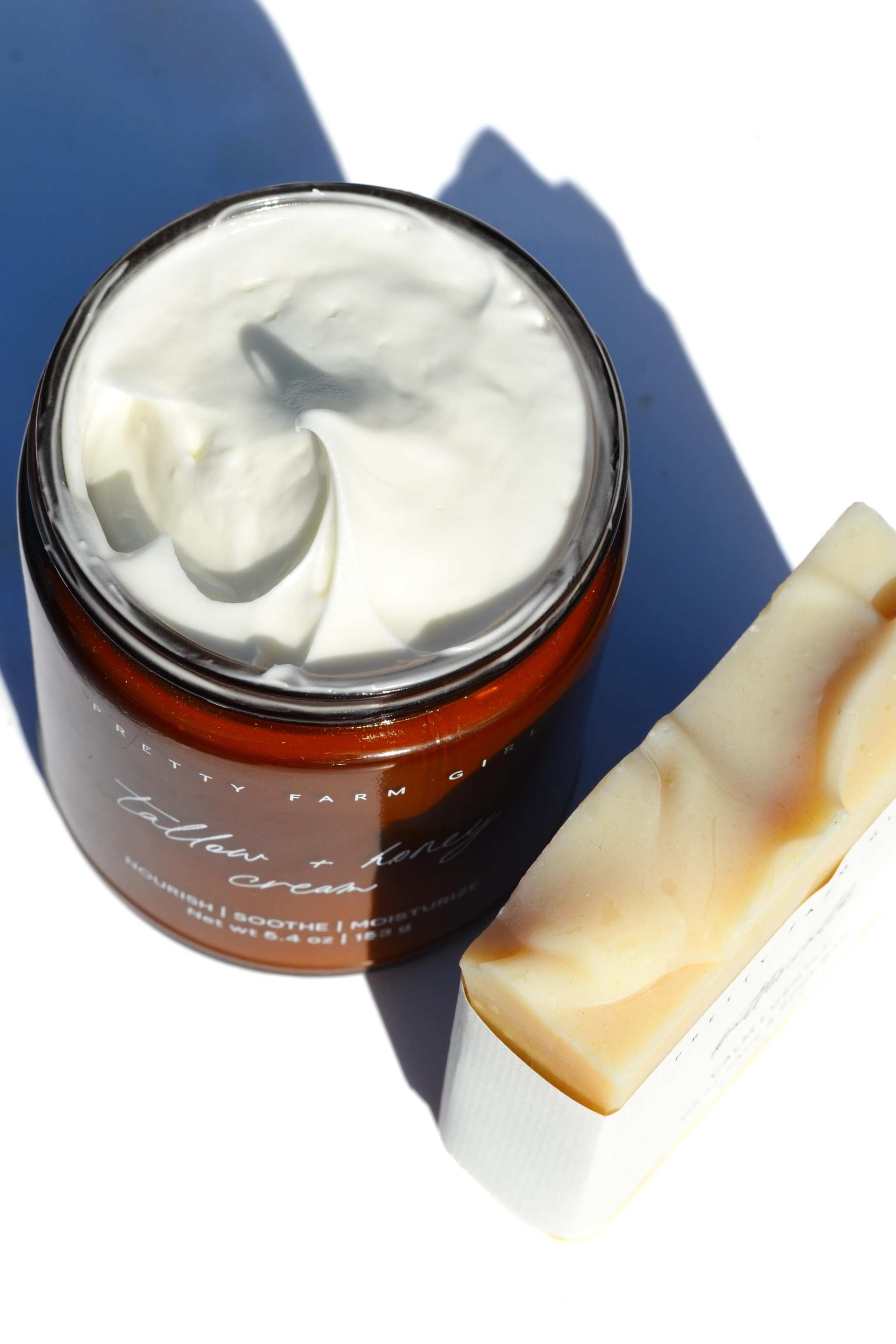 Gentle Care Duo for Mom + Baby featuring whipped white tallow body butter in an amber jar and cream soap bar