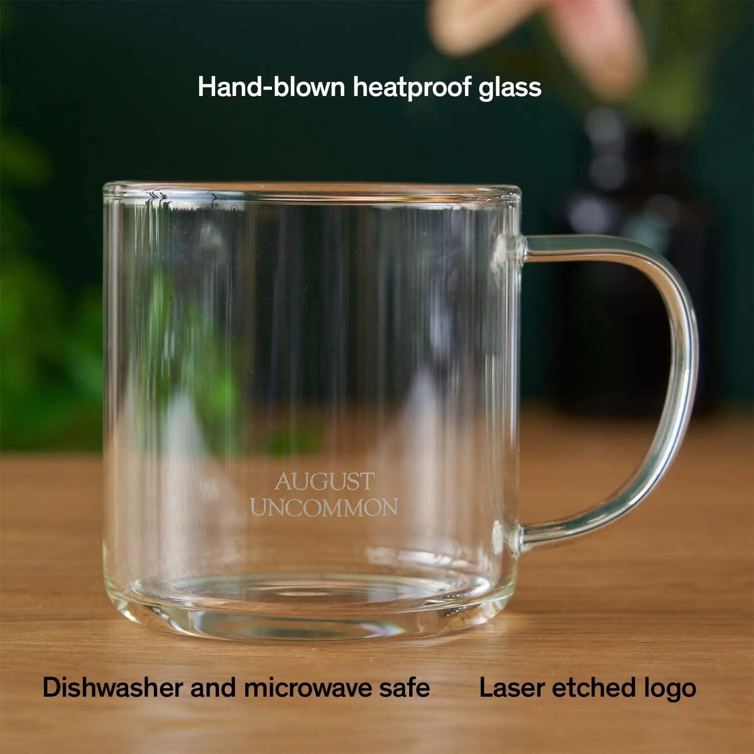 Glass Mug made from clear heatproof glass, with a cylindrical shape, rounded handle and laser-etched logo