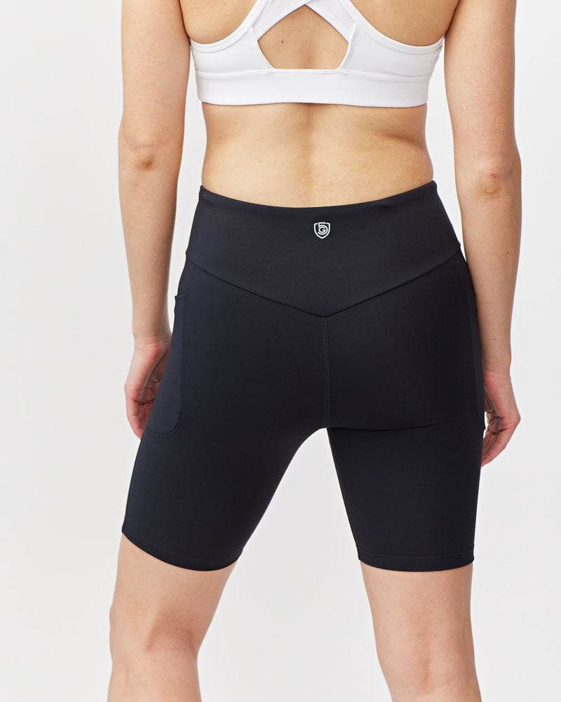 Go Again Bike Short in black stretchy knit fabric with an 8-inch inseam, sculpting fit, and V-shaped waistband
