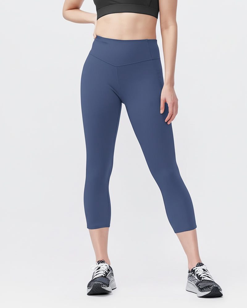 Go Again Crop Legging in solid navy stretch fabric, featuring a high-rise V-shaped waistband and cropped length