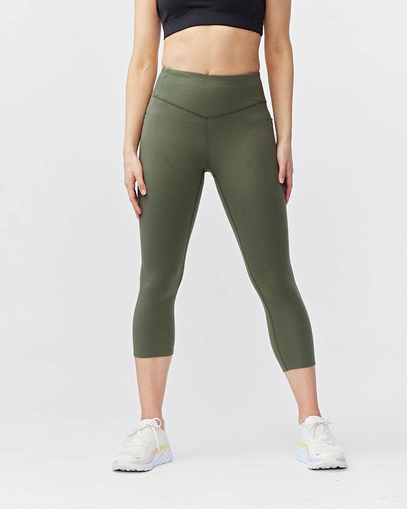 Go Again Crop Legging in olive green stretch fabric, featuring a high-rise V-shaped waistband and cropped legs