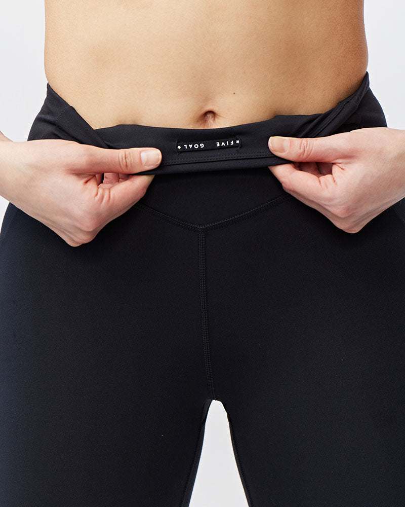 Go Again Full Length Legging in black stretch fabric with a high-rise waistband and small white logo label