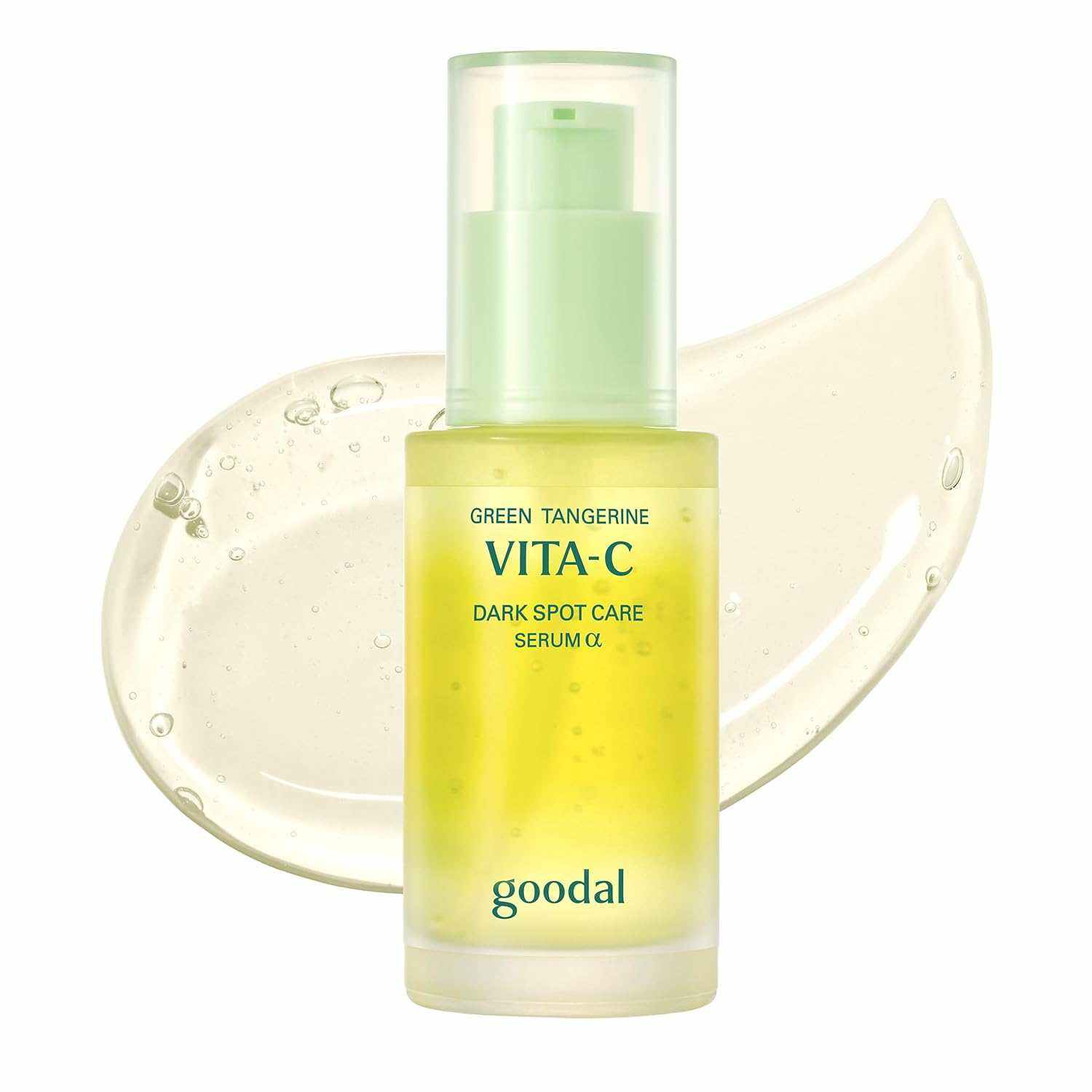 Goodal Green Tangerine yellow and green vitamin C dark spot serum bottle with clear gel texture in background