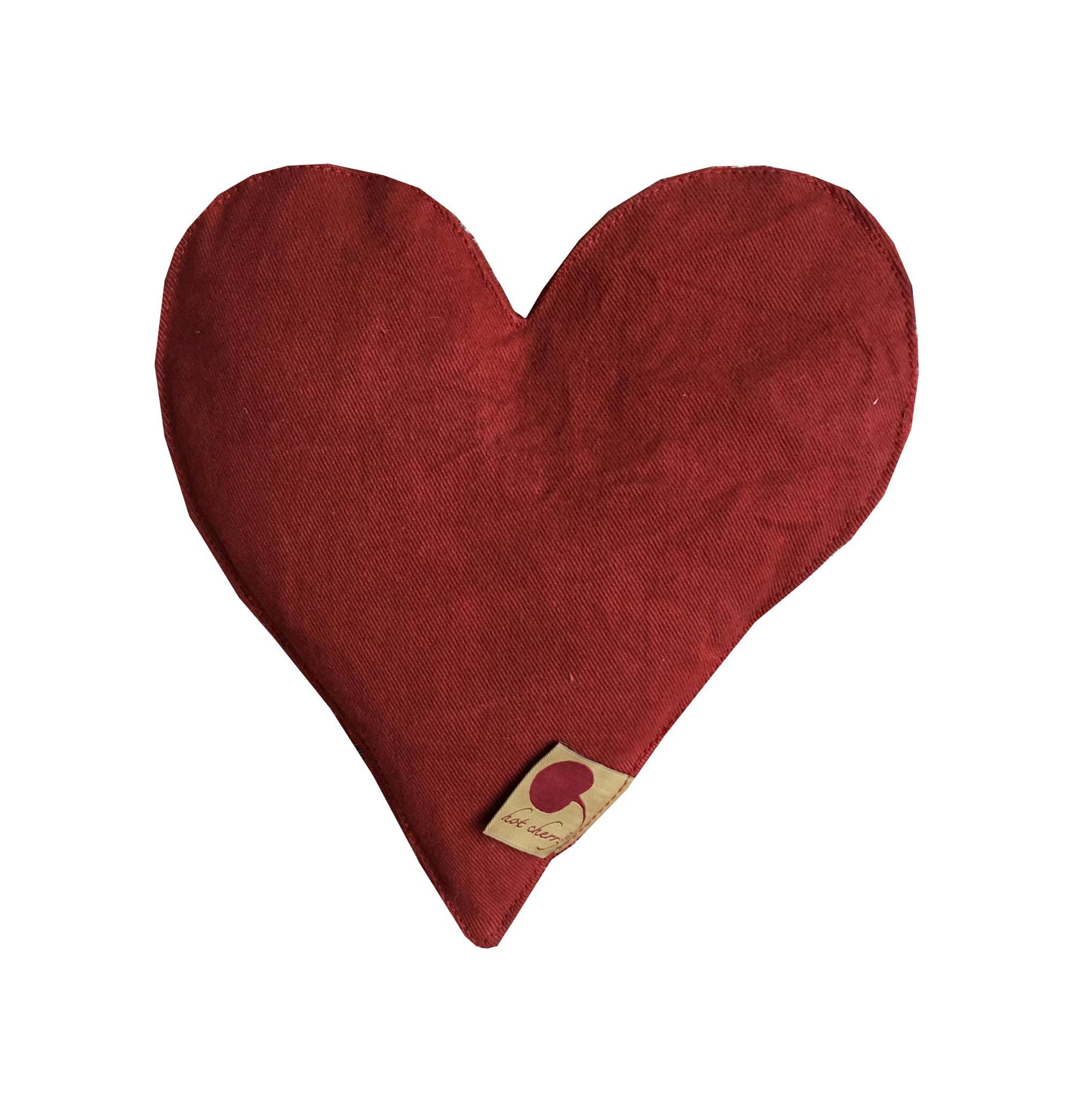 Heart-Shaped Pillow in deep red cotton denim with a soft textured finish and small branded tag