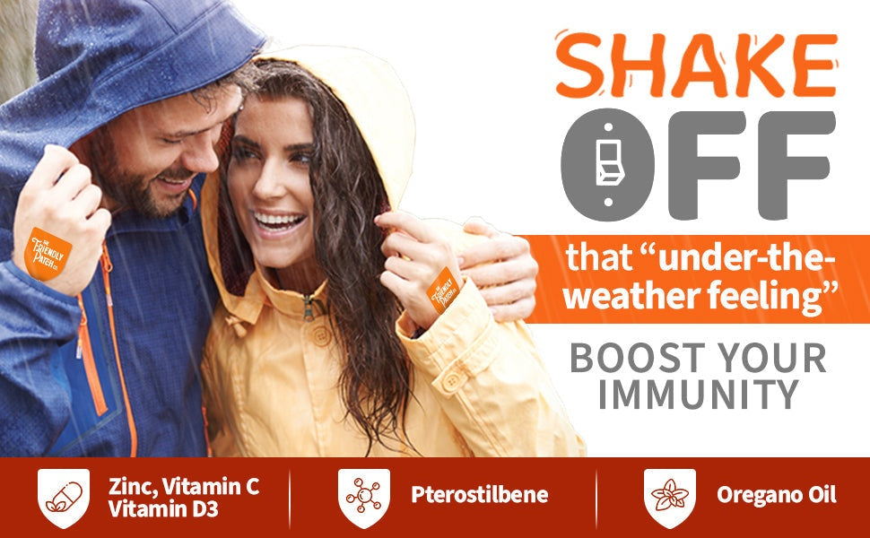 Couple wearing waterproof jackets with orange The Friendly Patch Immunity Patches on wrist and forearm promoting immune support.