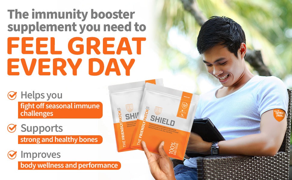 Immunity Patches in white and orange packaging held by a person wearing a light blue shirt with an orange patch on their arm.