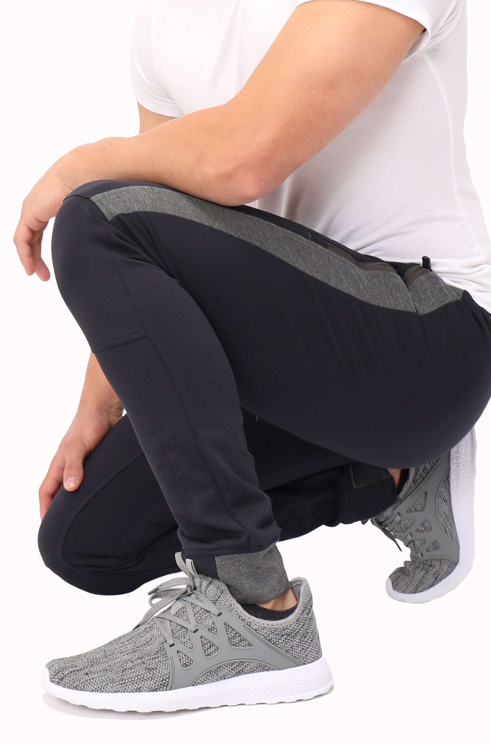 Infinite Flex Jogger in black stretch fabric with grey contrast panels, cuffed ankles and a flexible athletic fit
