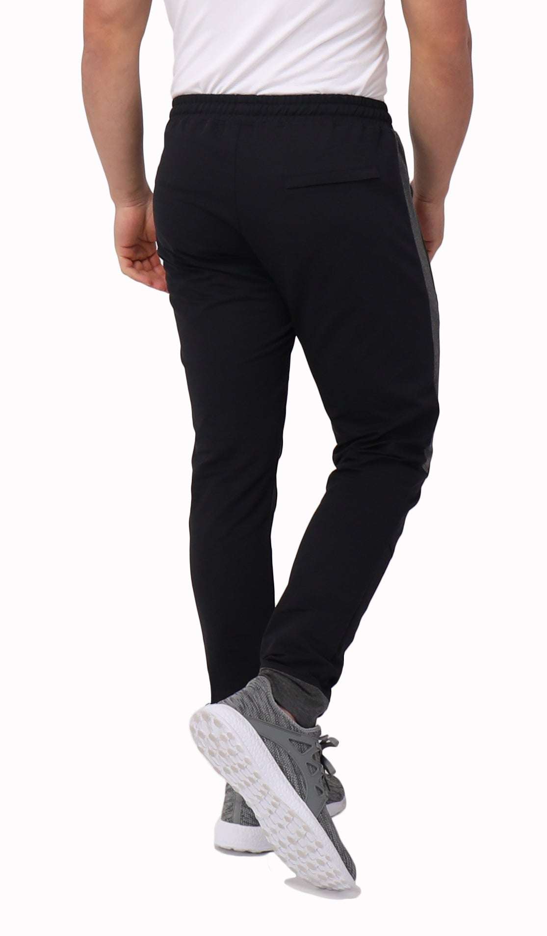 Infinite Flex Jogger in black stretch fabric, featuring a gathered waistband, tapered legs, and cuffed hems.