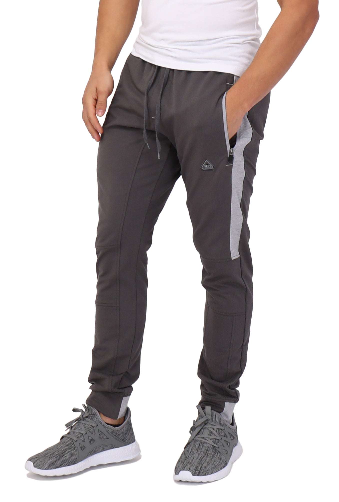 Infinite Flex Jogger in charcoal gray stretch fabric, with drawstring waistband, zip pockets, contrast side panels and cuffed ankles