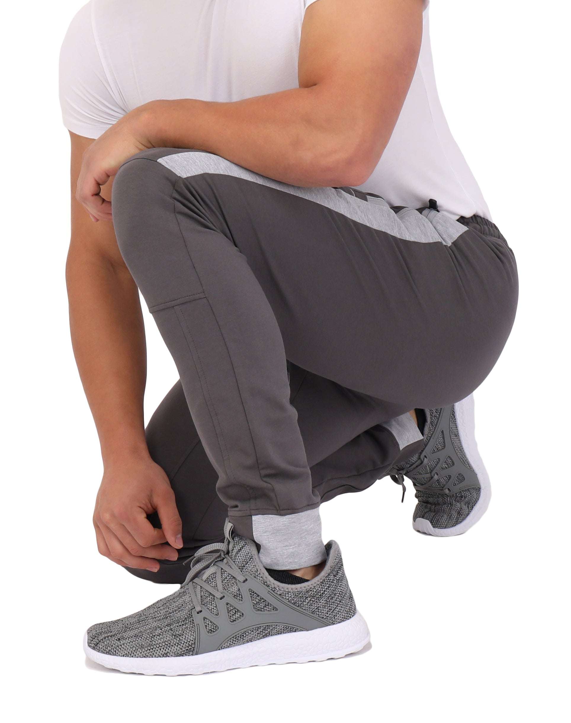 Infinite Flex Jogger in charcoal gray stretch fabric with tapered legs, cuffed ankles, and light gray side panels