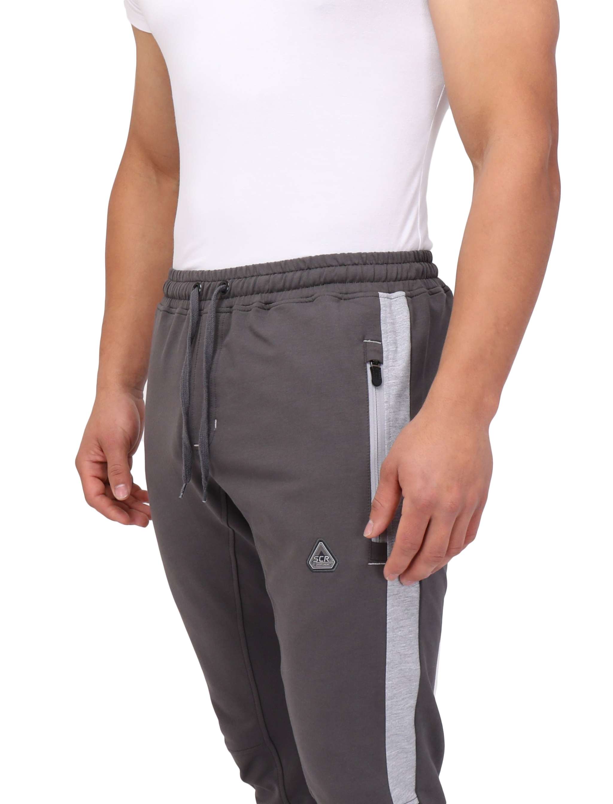 Infinite Flex Jogger in charcoal gray stretch fabric with a light gray side stripe, drawstring waist, and zippered pocket