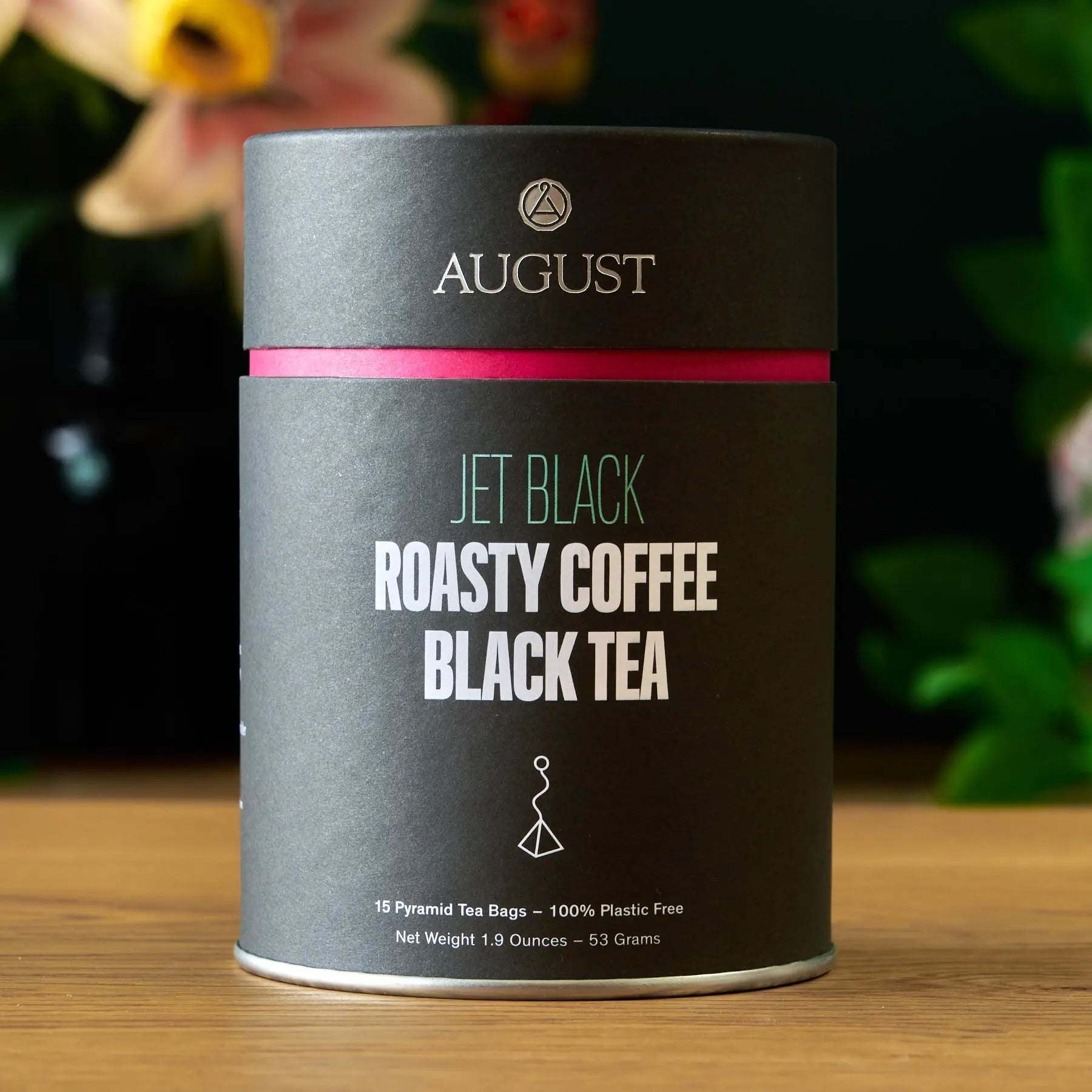 Black tea tin, Jet Black - Roasty Coffee Black Tea - 15 Bags, dark gray metal with pink accent band.