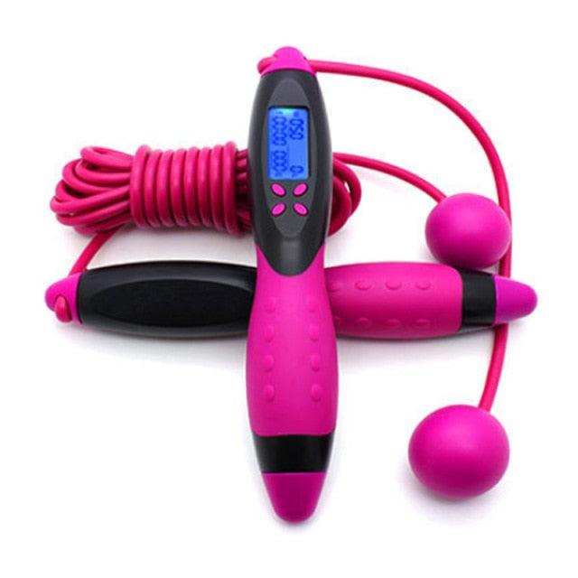 Jump Ropes With Electronic Counting feature pink rubber handles with black grips, an LCD screen, and include a pink rotating cordless skipping option.