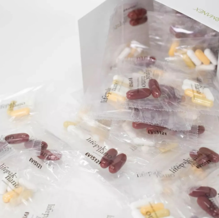 Lifepak® Nano vitamin supplement sachets with clear packets of burgundy, white and yellow capsules and softgels