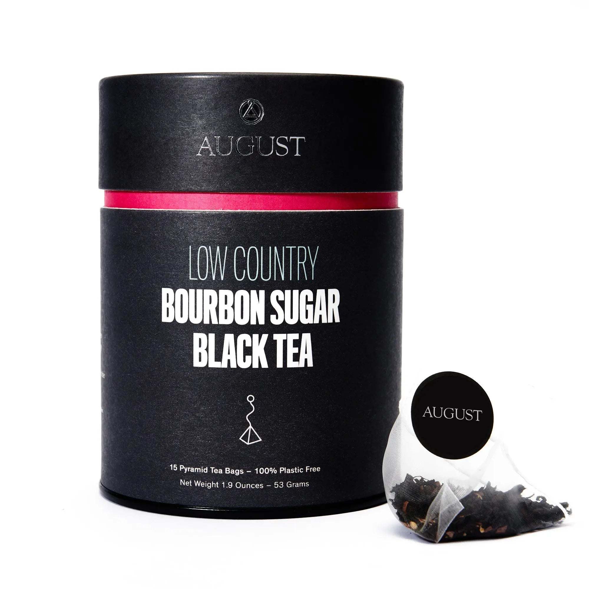 Low Country black tea in a black cylindrical tin with a vivid pink band, shown with a pyramid tea bag