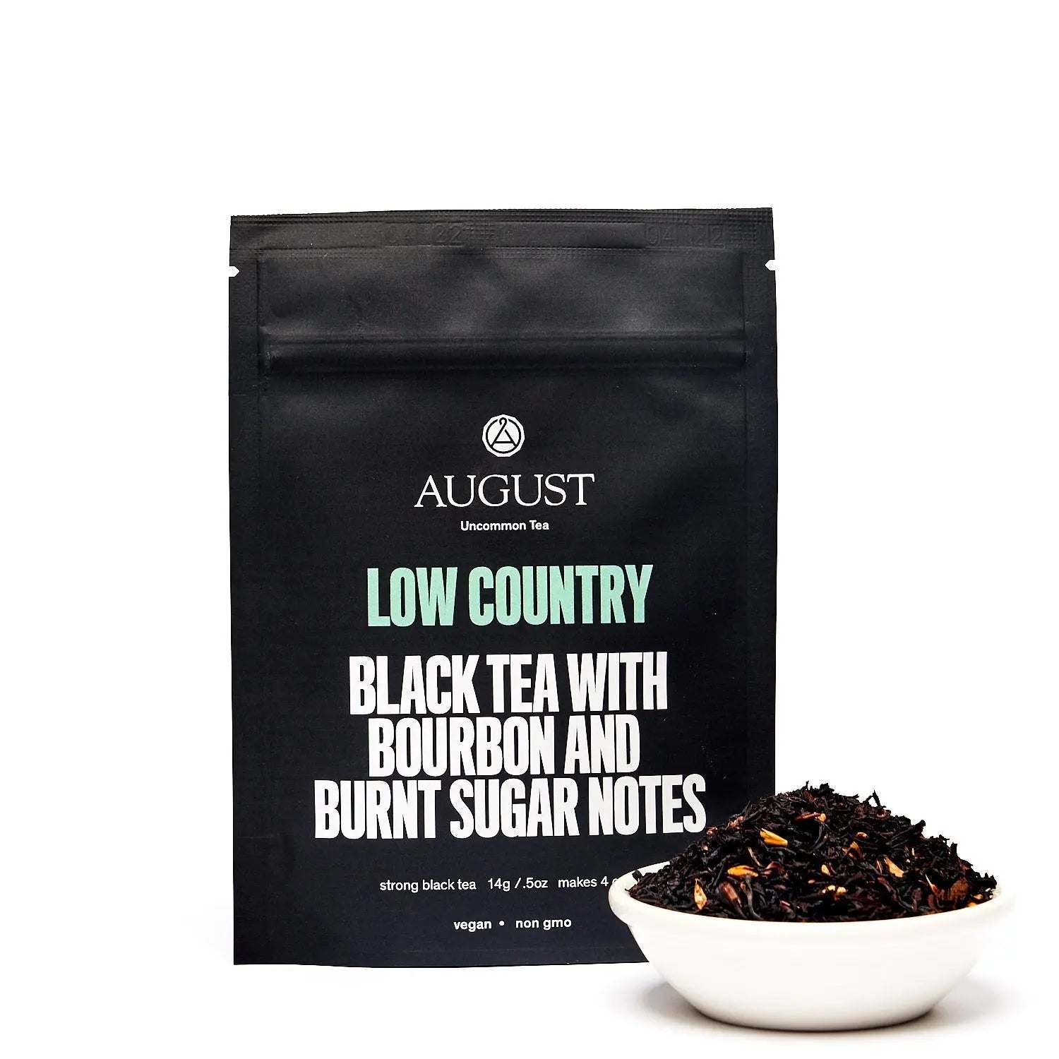 Low Country Black Tea in black matte pouch with bourbon and burnt sugar notes, shown with loose black tea in white bowl