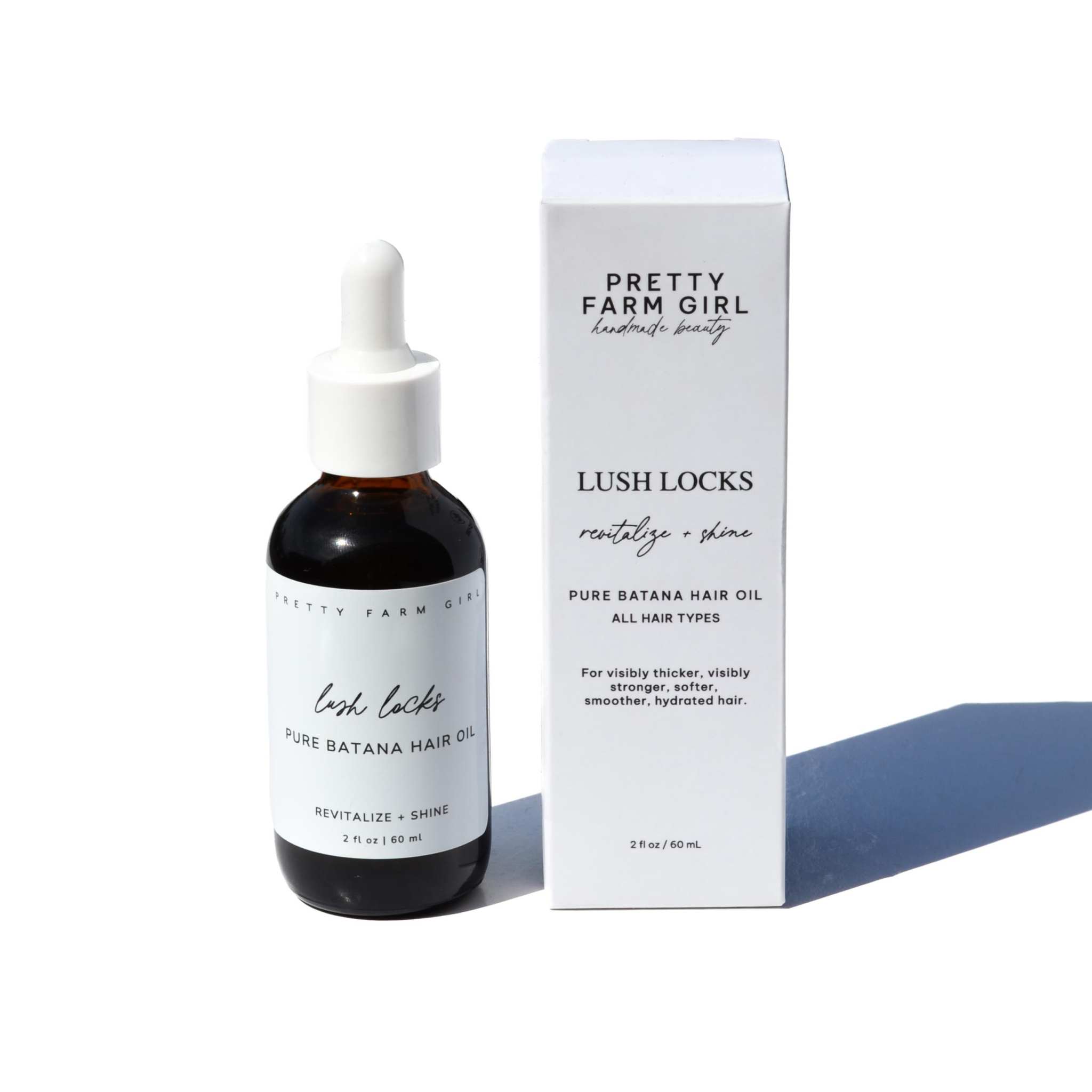 Lush Locks - Natural Batana Hair Oil in a dark glass dropper bottle with white label and matching box