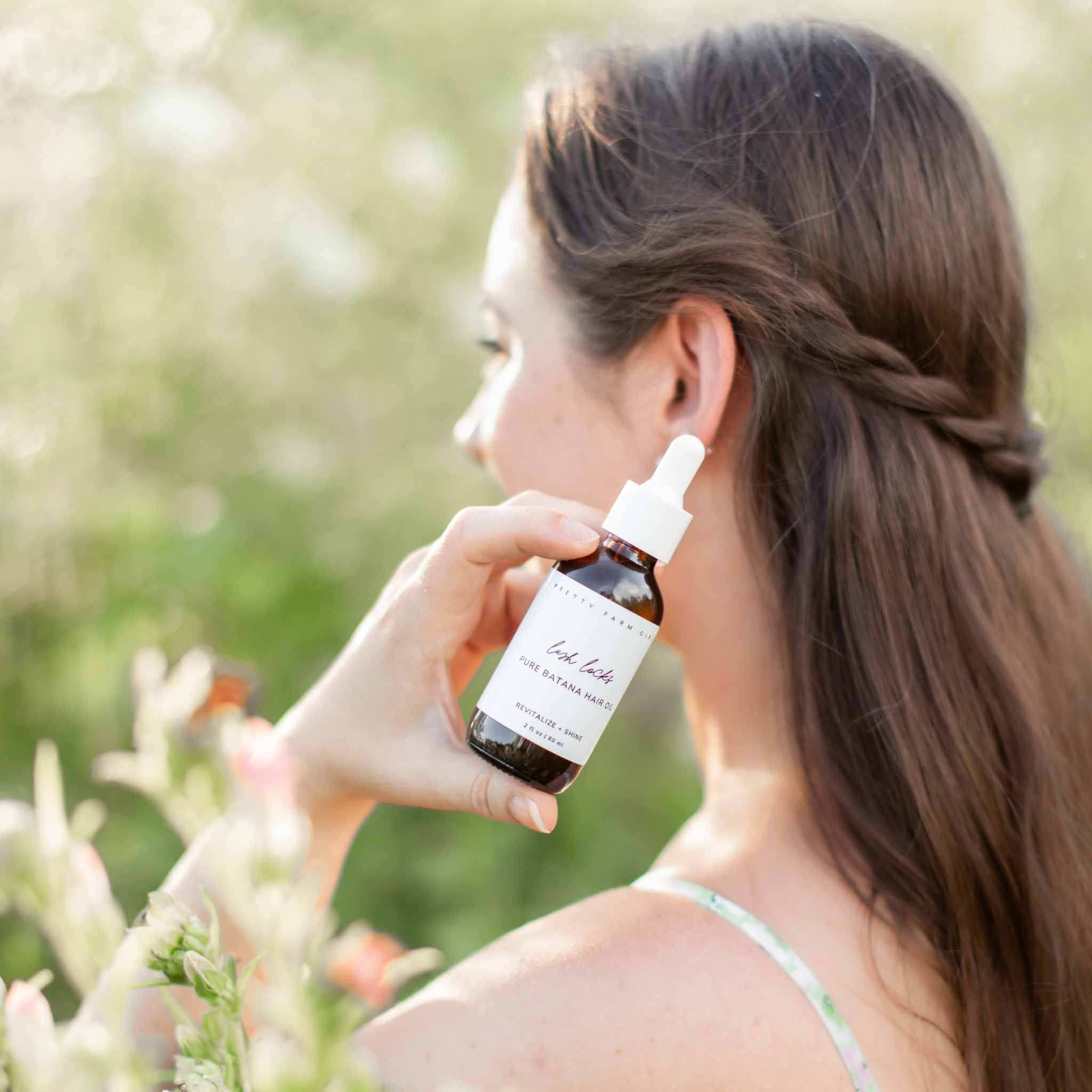 Lush Locks - Natural Batana Hair Oil in a brown glass dropper bottle with white label and cap
