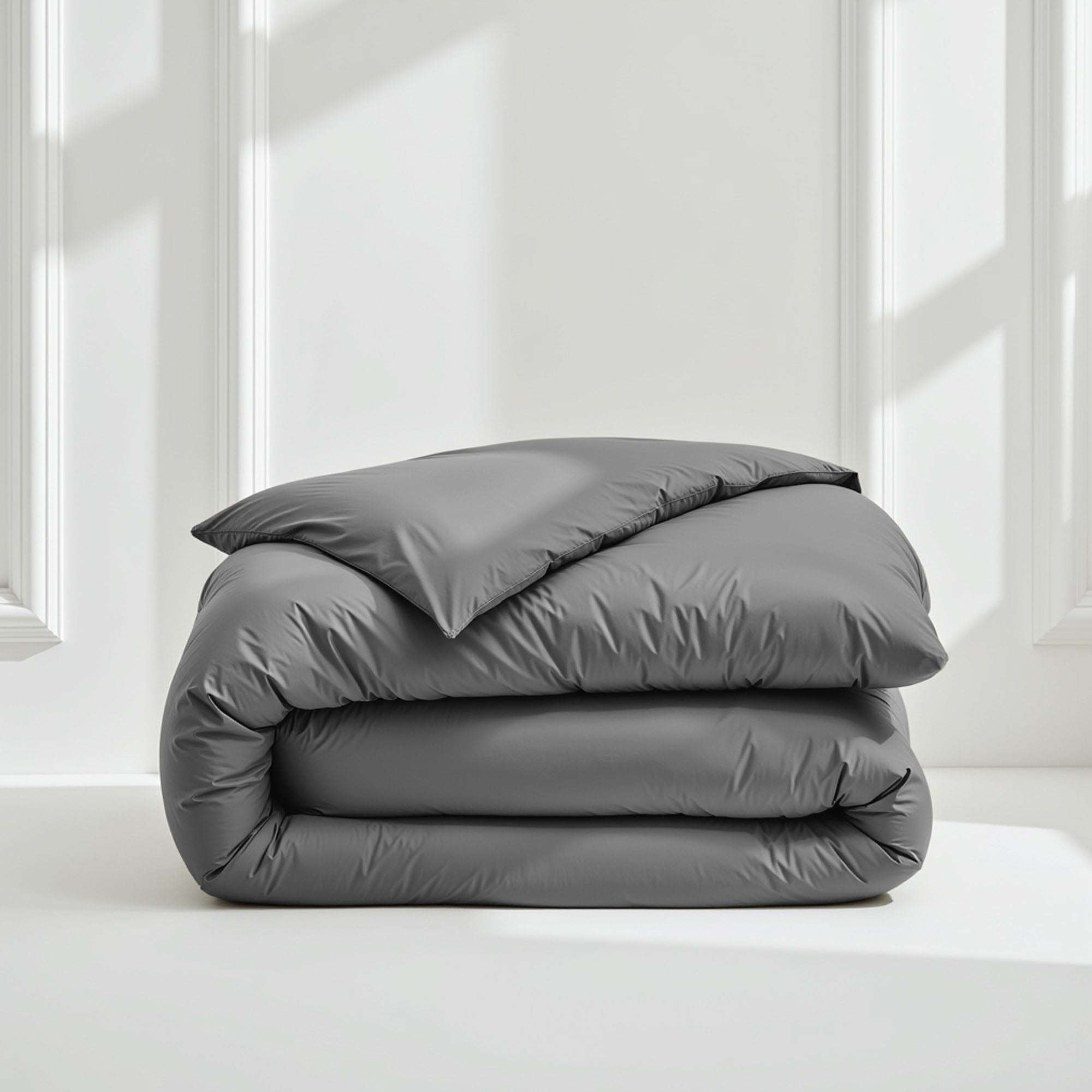 Luxe Australian Sateen Bedding bundle with a charcoal gray, softly lustrous duvet cover folded into a plush stack