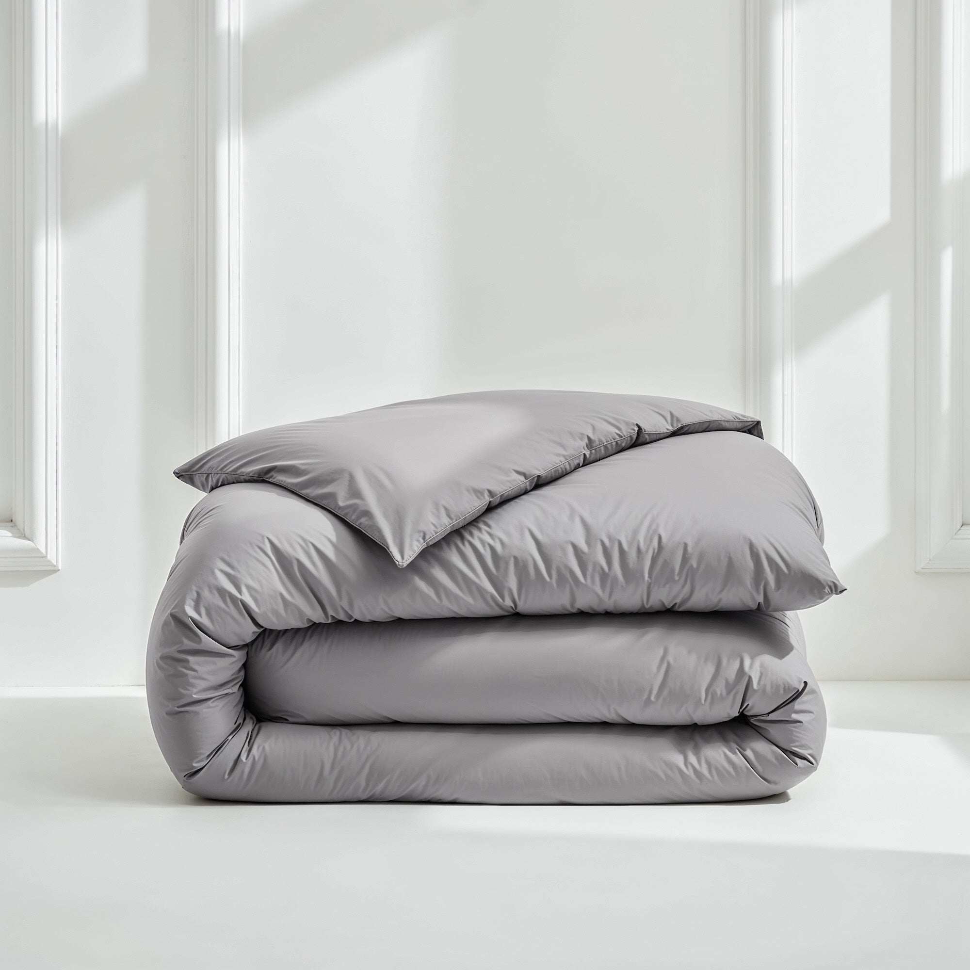Luxe Australian Sateen Bedding bundle in smooth gray cotton, neatly folded with a duvet cover and pillowcases