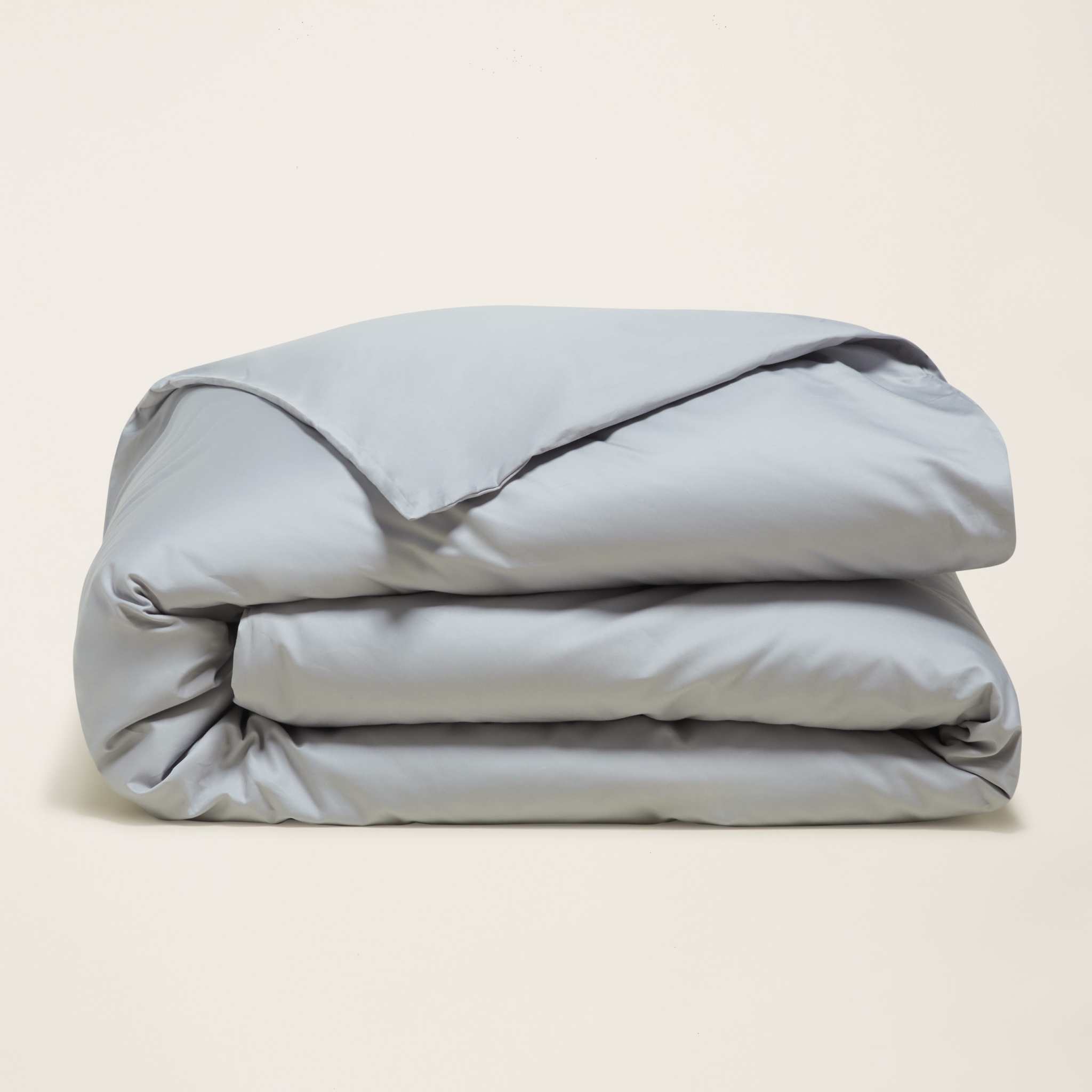 Luxe Australian Sateen Bedding duvet cover in solid pale blue-gray cotton sateen, folded with a smooth finish