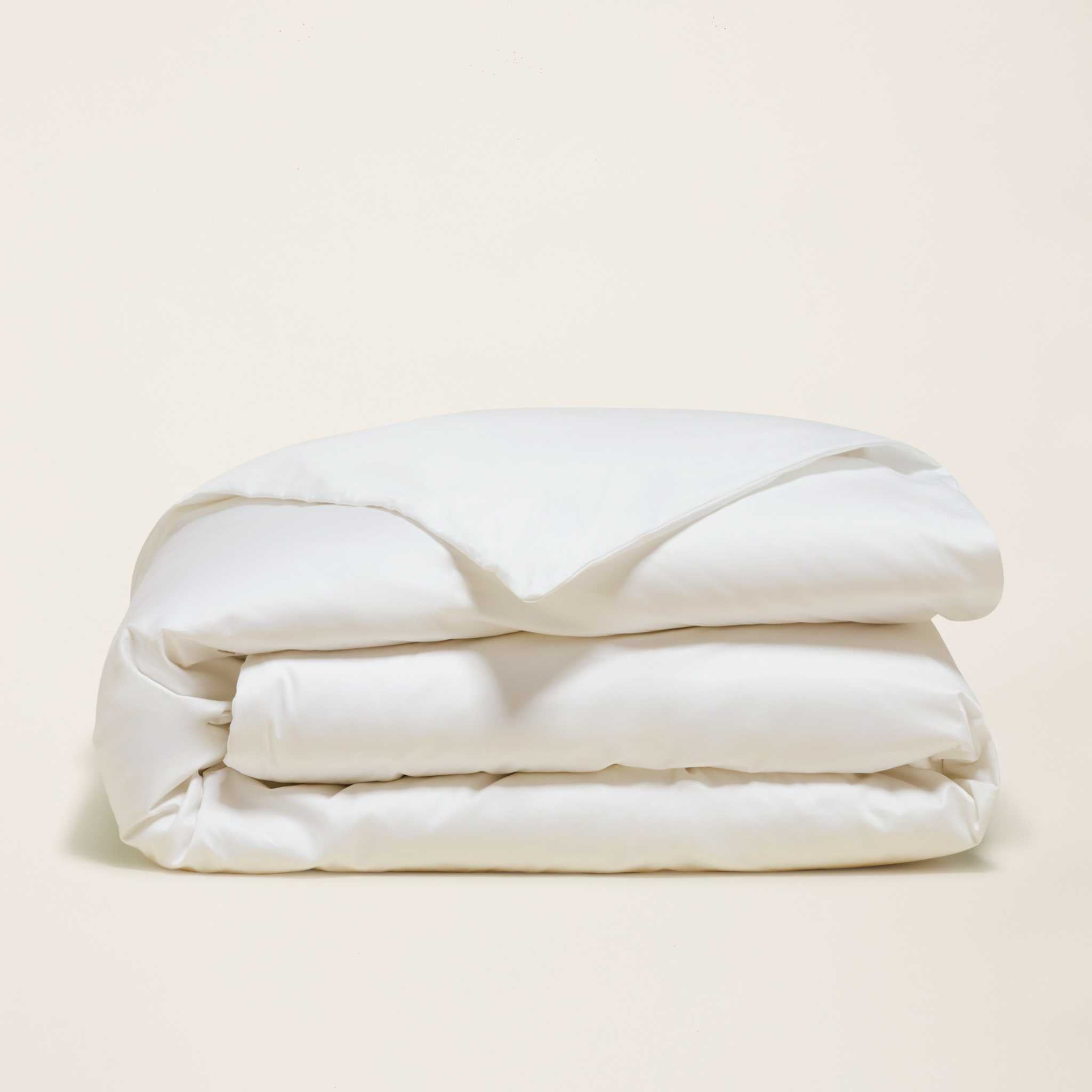 Luxe Australian Sateen Bedding bundle in white cotton sateen, folded into a soft, layered stack