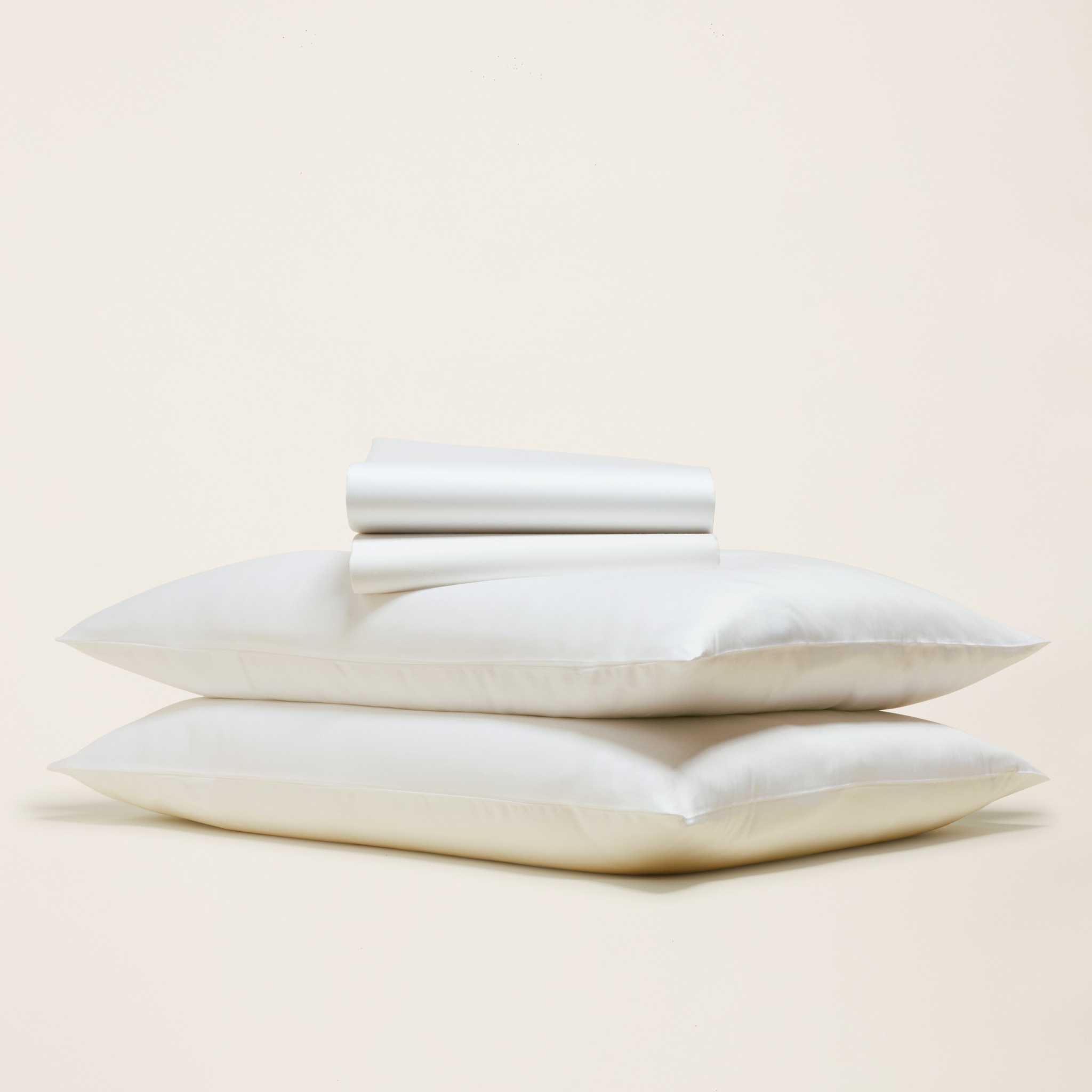 Bedding bundle in Luxe Australian Sateen Bedding, featuring white cotton sateen pillowcases and neatly folded sheets