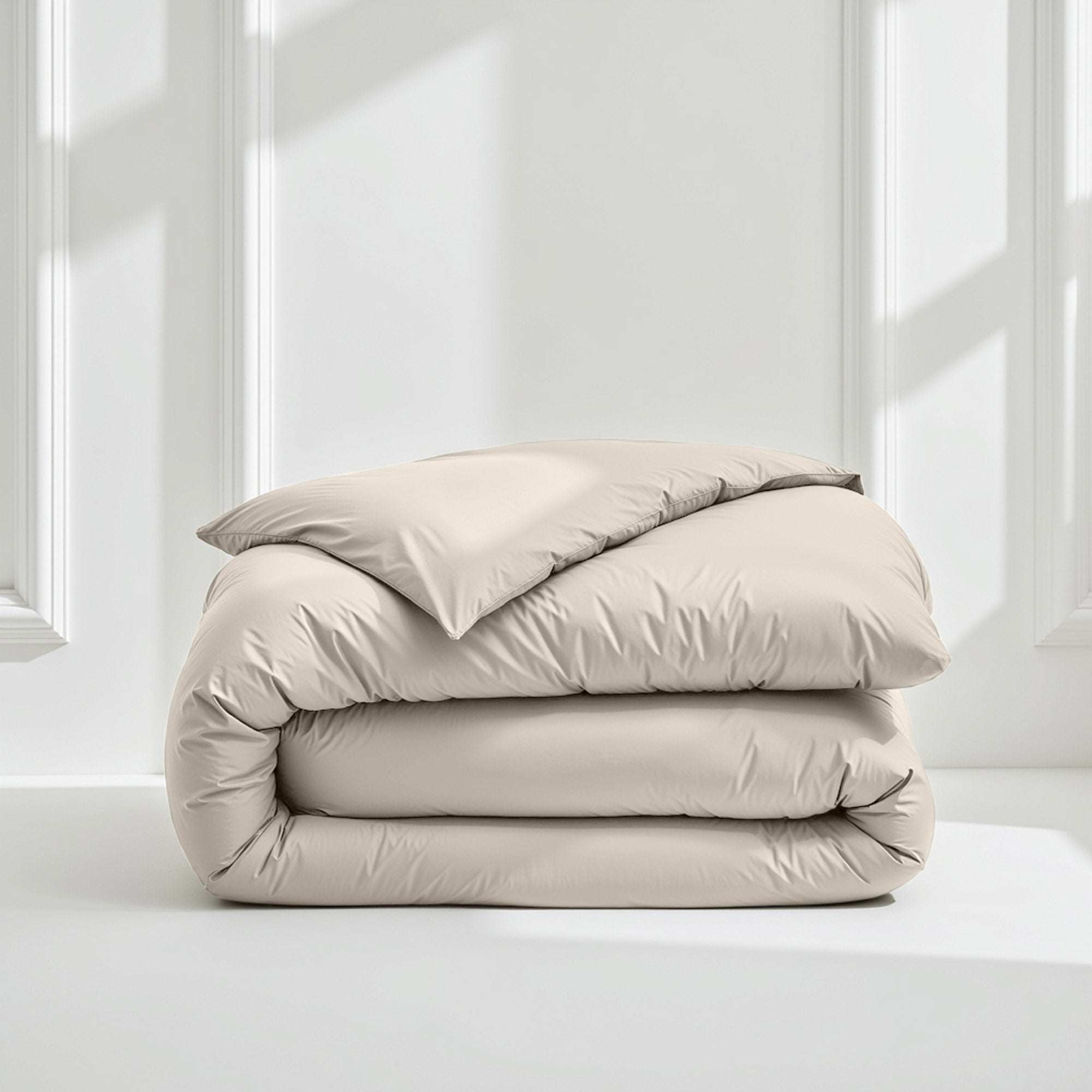 Duvet cover in Luxe Australian Sateen, smooth ivory cotton with a subtle sheen, folded into a plush stack