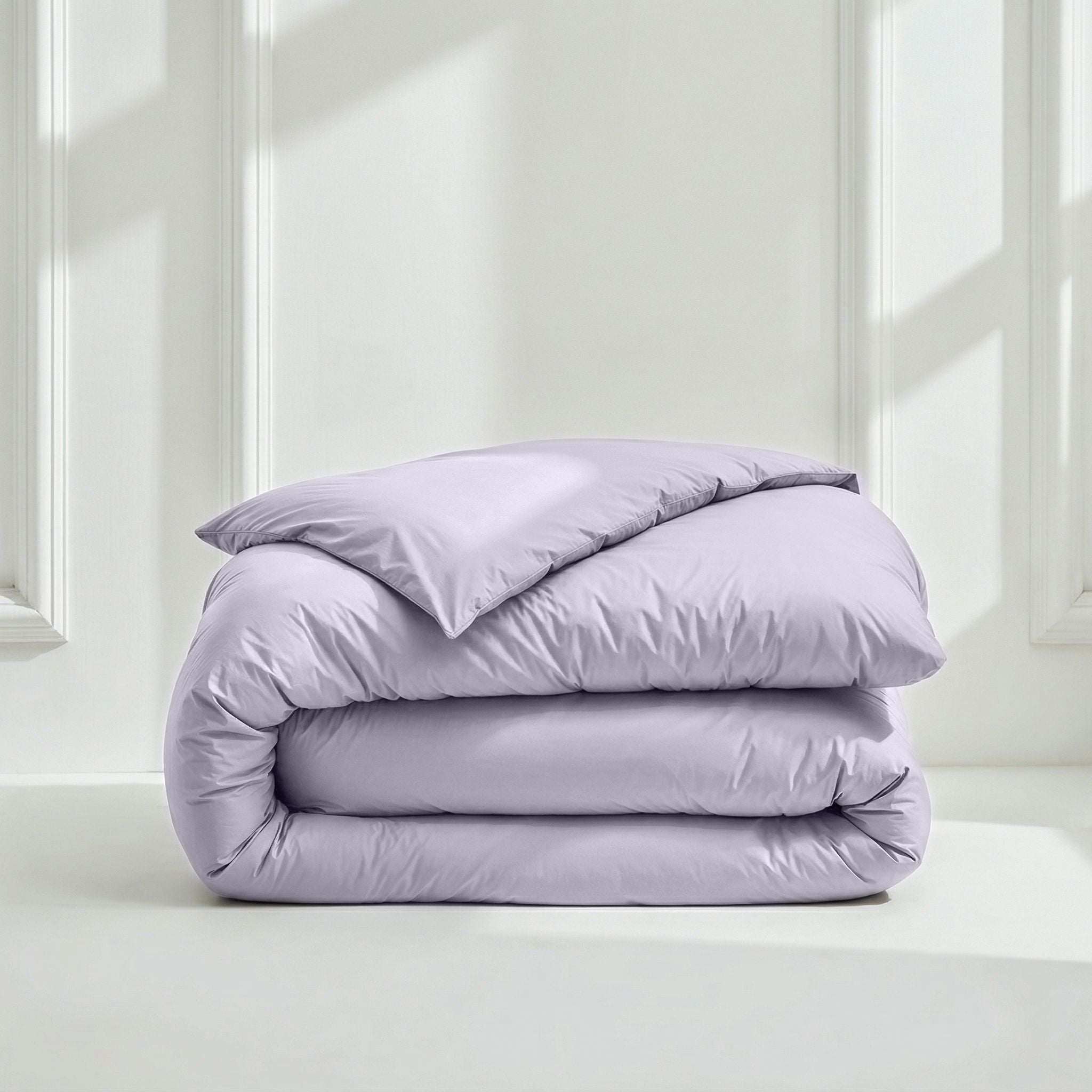 Luxe Australian Sateen duvet cover in soft lavender cotton with a smooth finish, folded into a neat stack