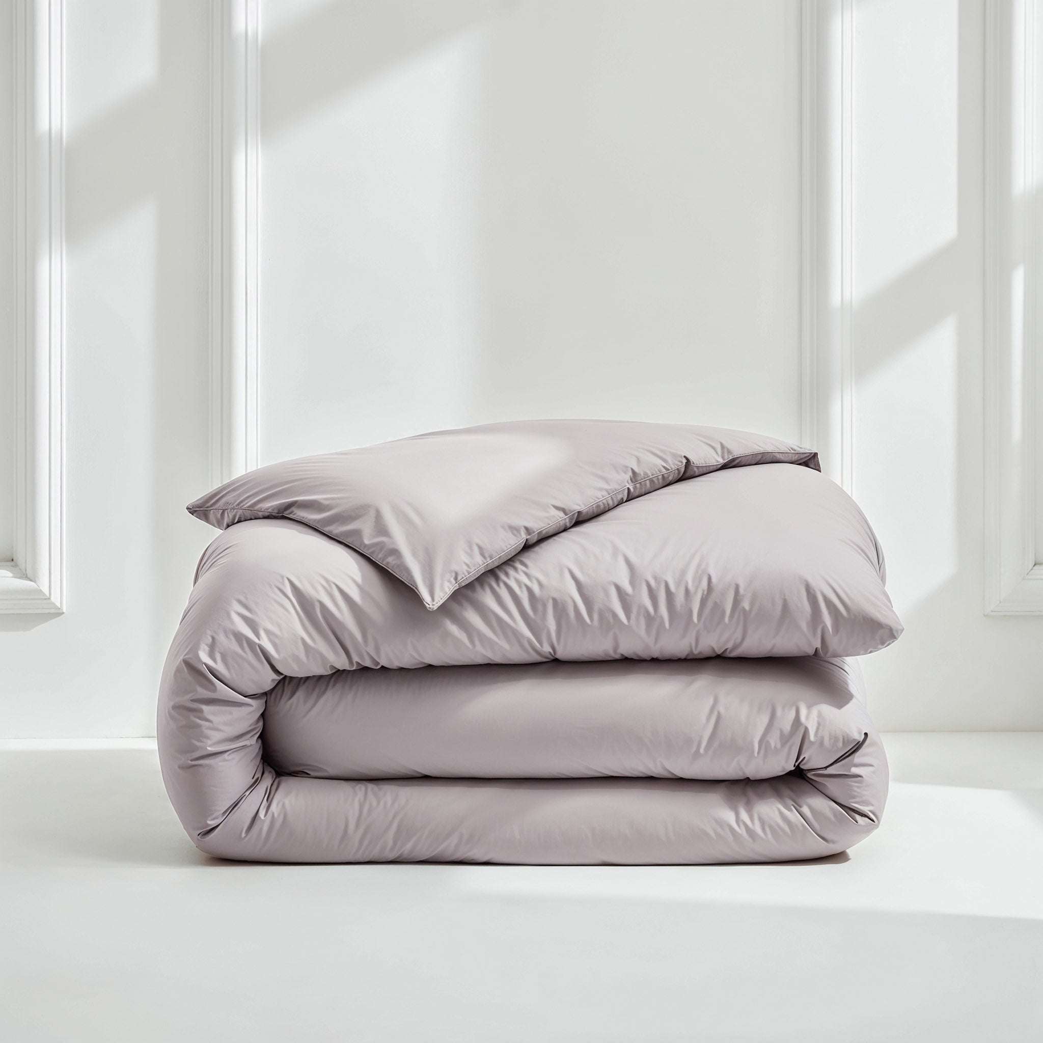 Luxe Australian Sateen duvet cover in pale lavender cotton with a smooth, subtly lustrous finish, folded in soft layers