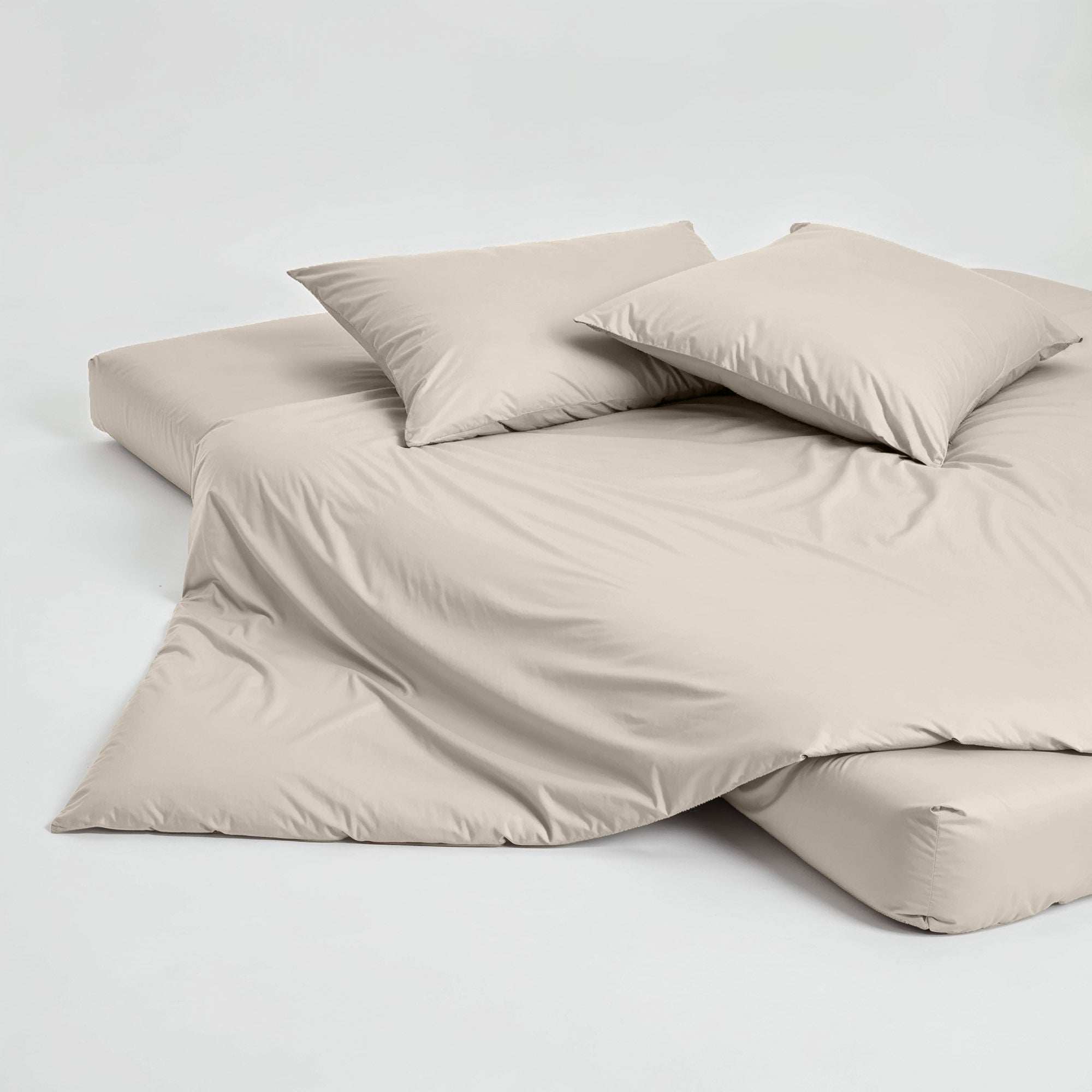Luxe Australian Sateen Pillowcase Set in soft warm beige cotton sateen, with two smooth pillows and matching bedding