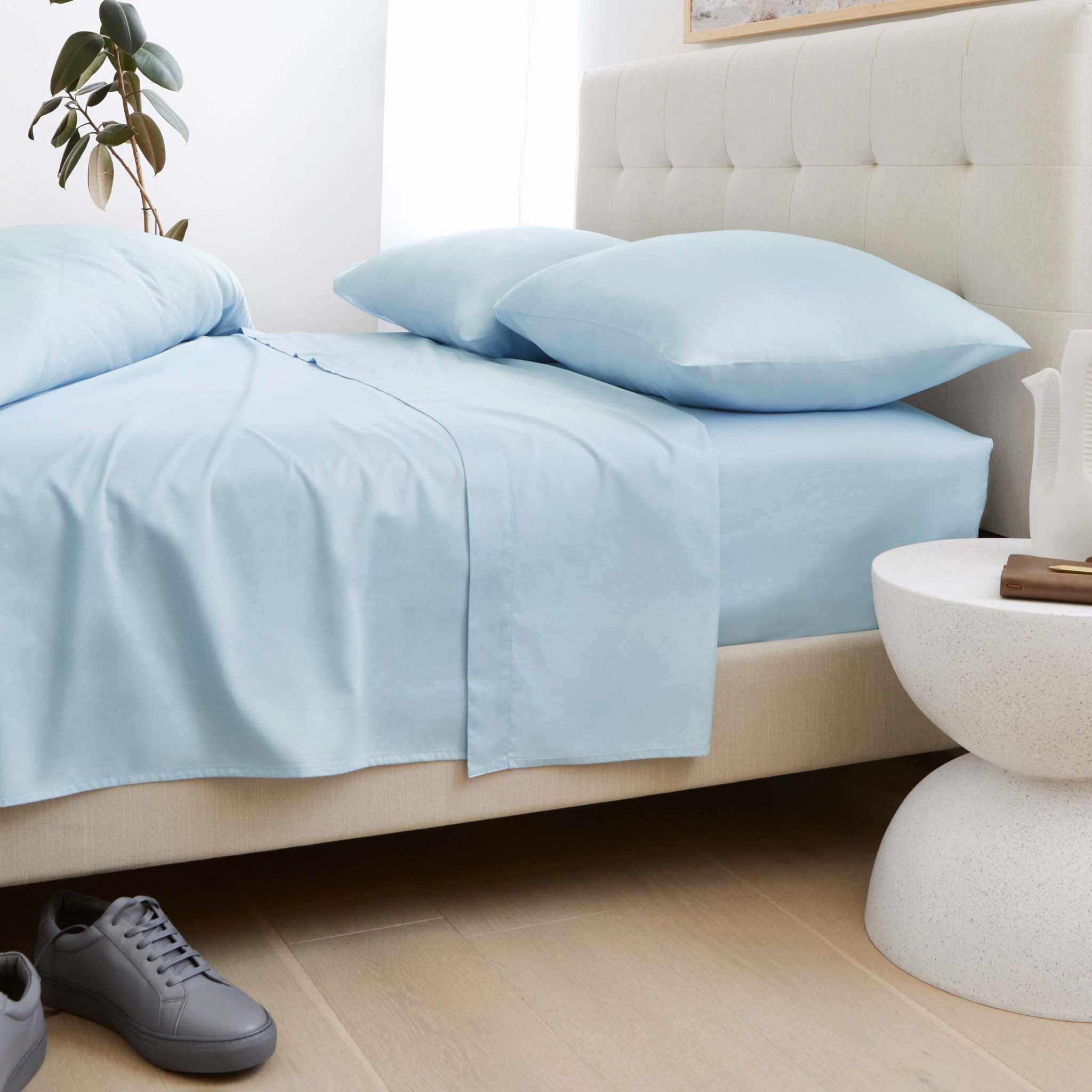 Luxe Australian Sateen Pillowcase Set in pale blue cotton with a smooth, silky sateen finish on a bed
