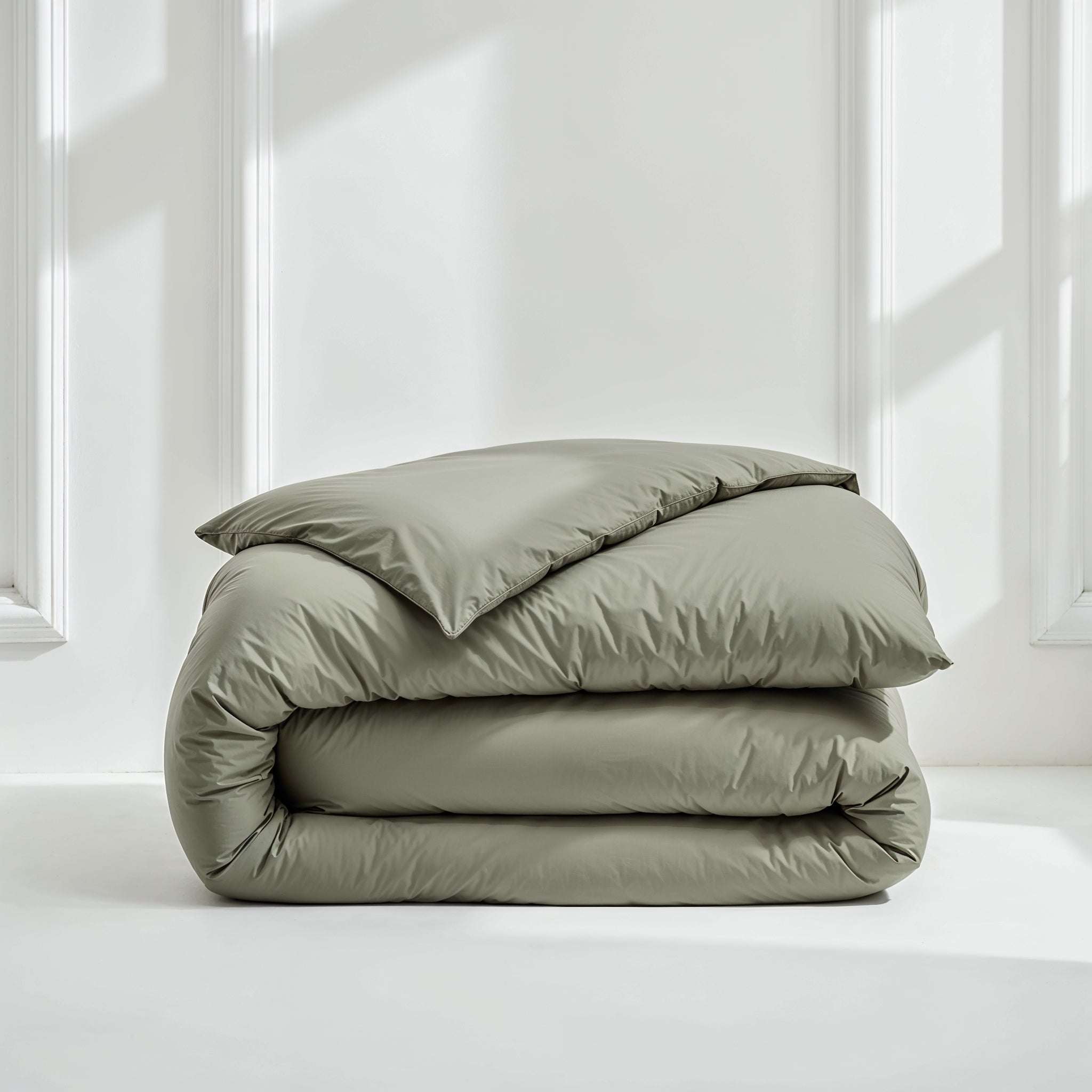Duvet cover in Luxe Australian Sateen, smooth sage green cotton with a subtle sheen, folded in soft layers