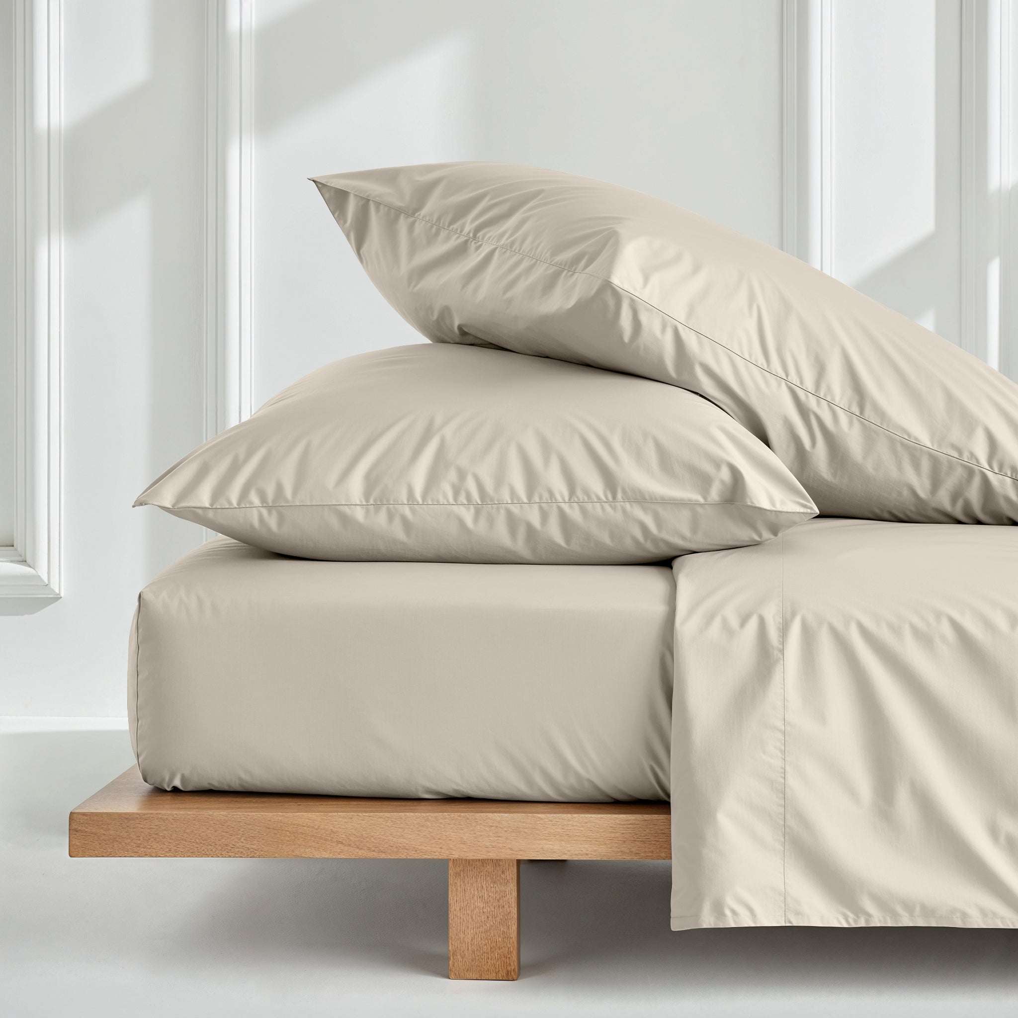 Luxe Australian Sateen Sheet Set in soft ivory cotton, with smooth fitted bedding and layered plump pillowcases