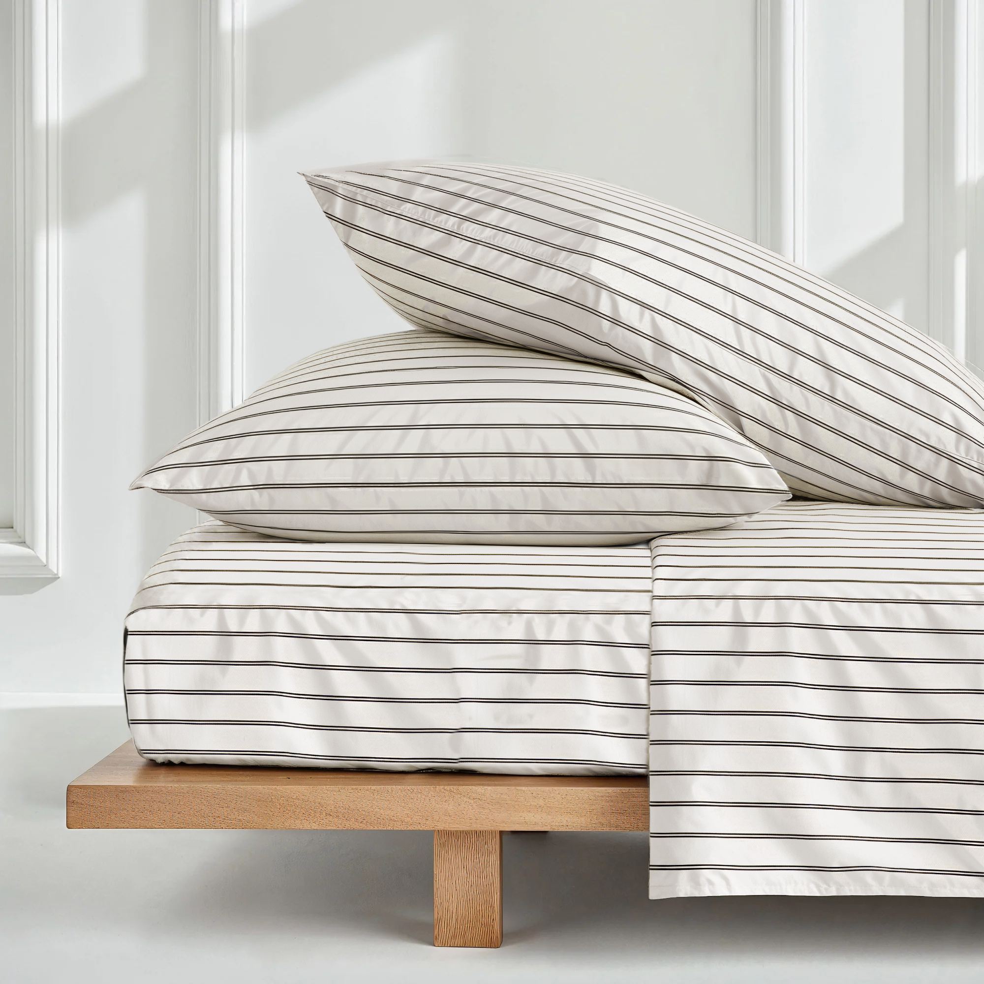 Luxe Australian Sateen Sheet Set in ivory cotton with fine horizontal taupe stripes, shown on pillows and bedding