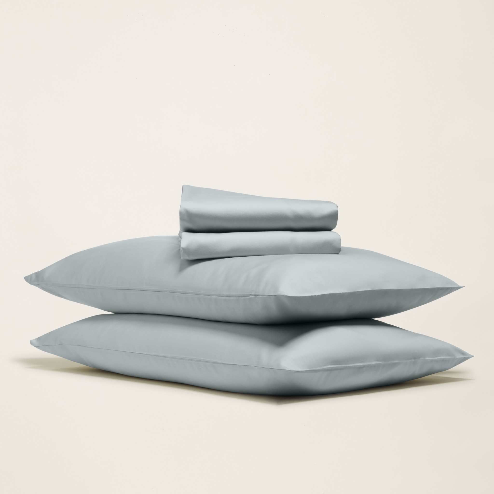 Luxe Australian Sateen Sheet Set in pale blue cotton sateen, shown as two smooth pillowcases with folded sheets