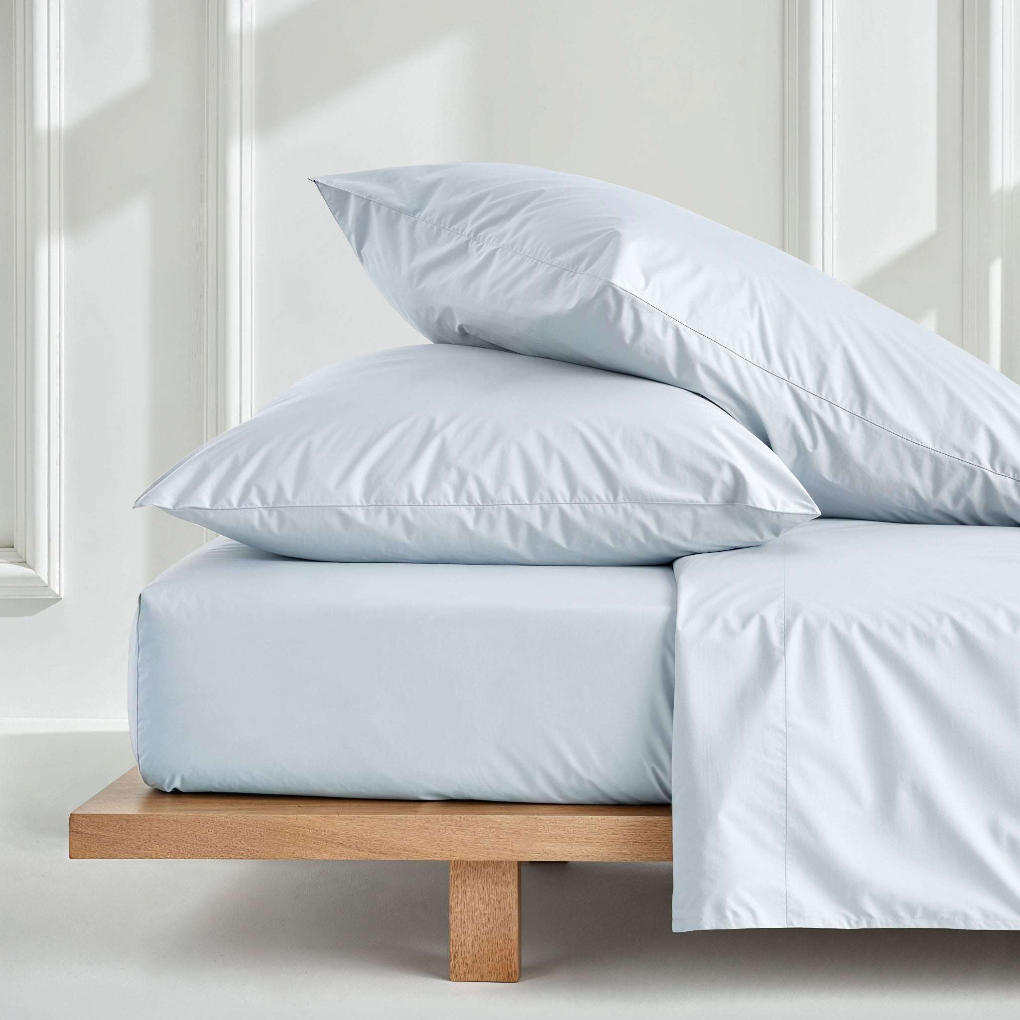 Luxe Australian Sateen Sheet Set in pale blue cotton, with smooth solid-colour sheets and matching pillowcases