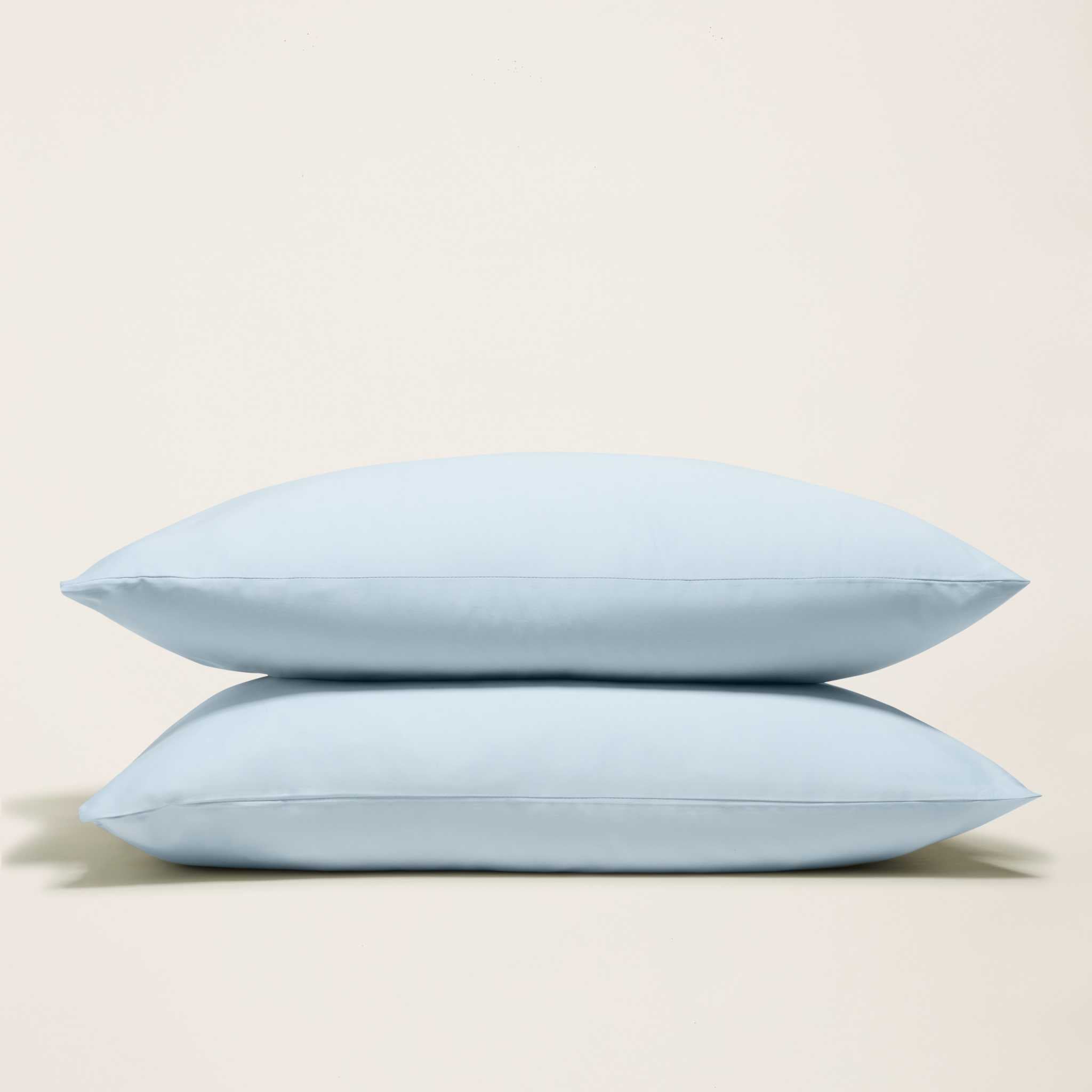 Luxe Australian Sateen Sheet Set includes two pale blue cotton sateen pillowcases with smooth fabric and piped edges