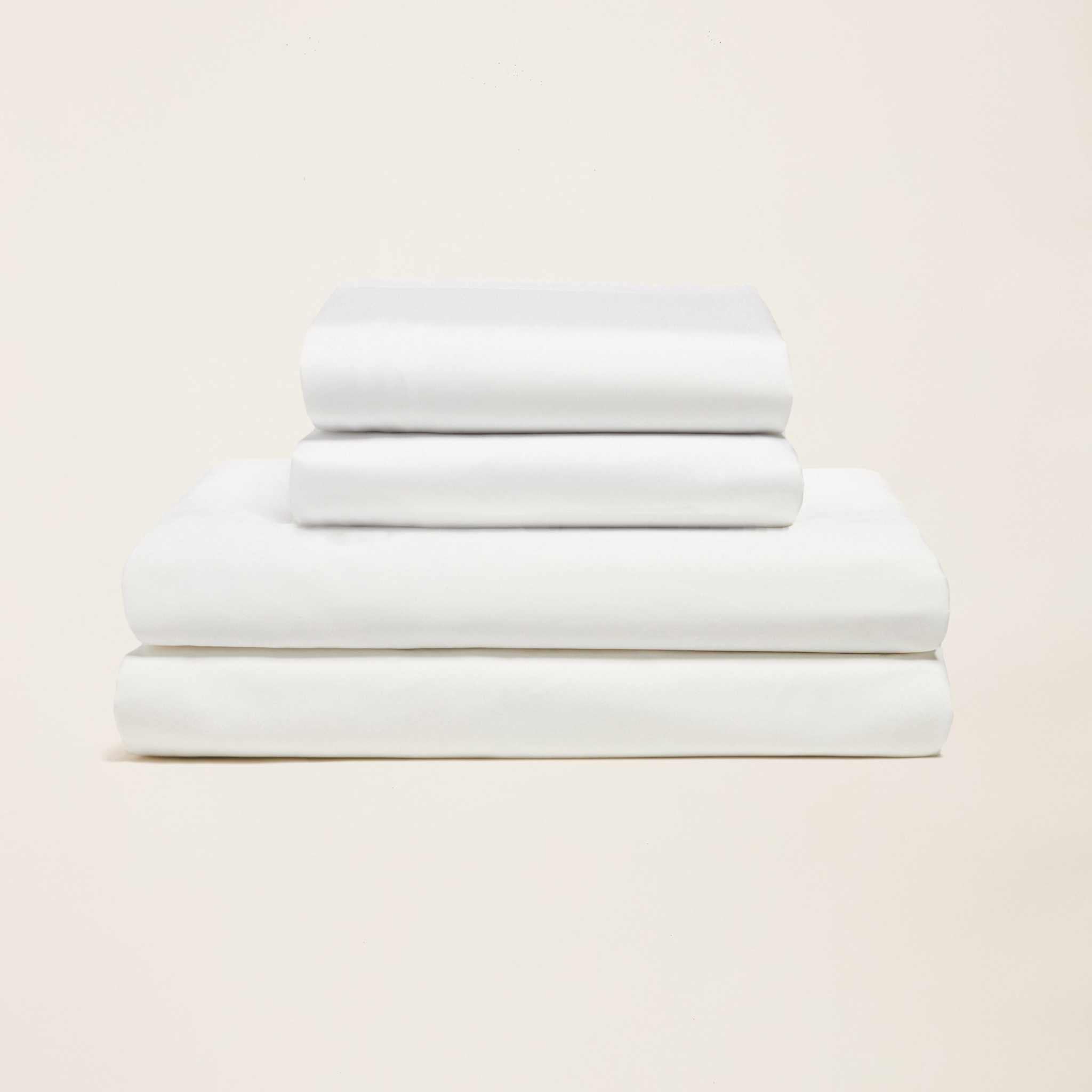Luxe Australian Sateen Sheet Set in crisp white cotton with a smooth sateen finish, neatly folded in a stack