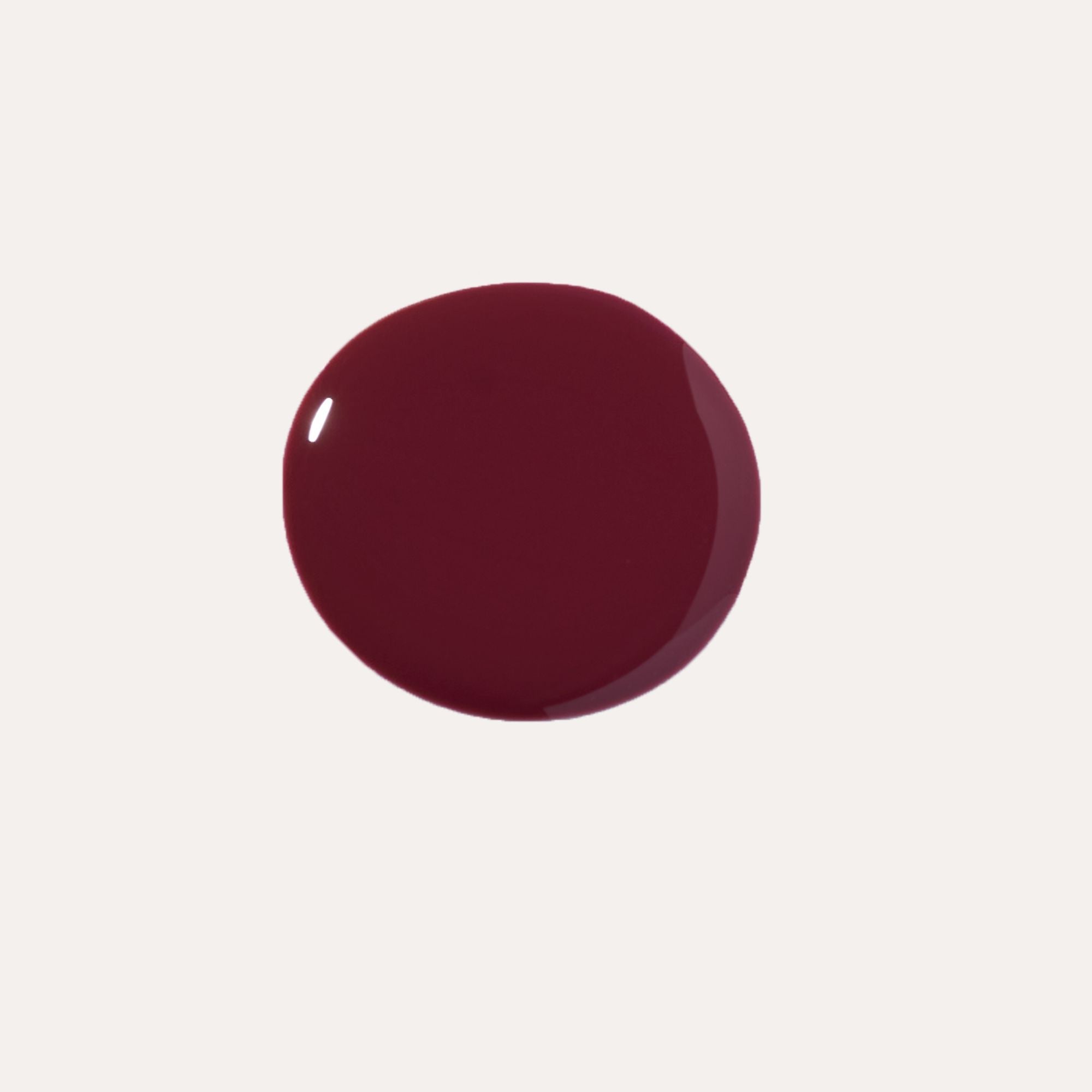 Luxe Lip Nourishing Oil in a deep burgundy shade, shown as a glossy, smooth oval swatch.