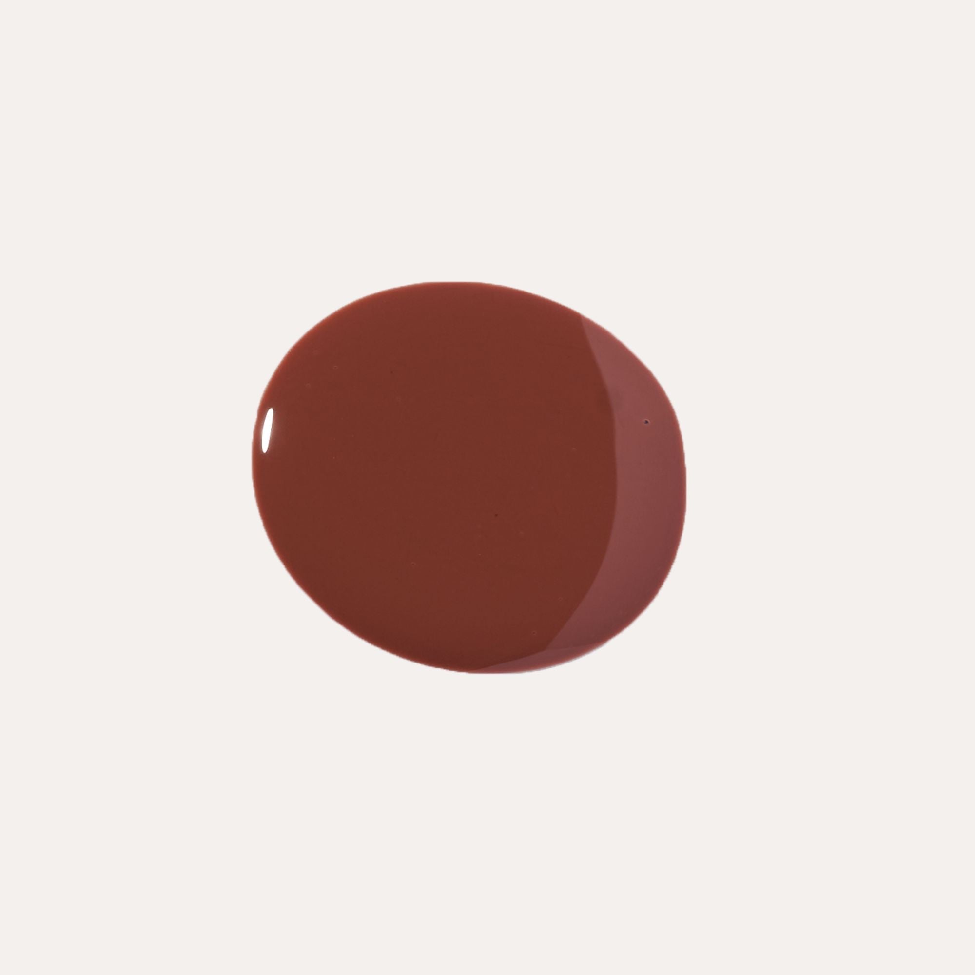 Luxe Lip Nourishing Oil in a glossy deep reddish-brown shade, shown as a smooth rounded swatch.